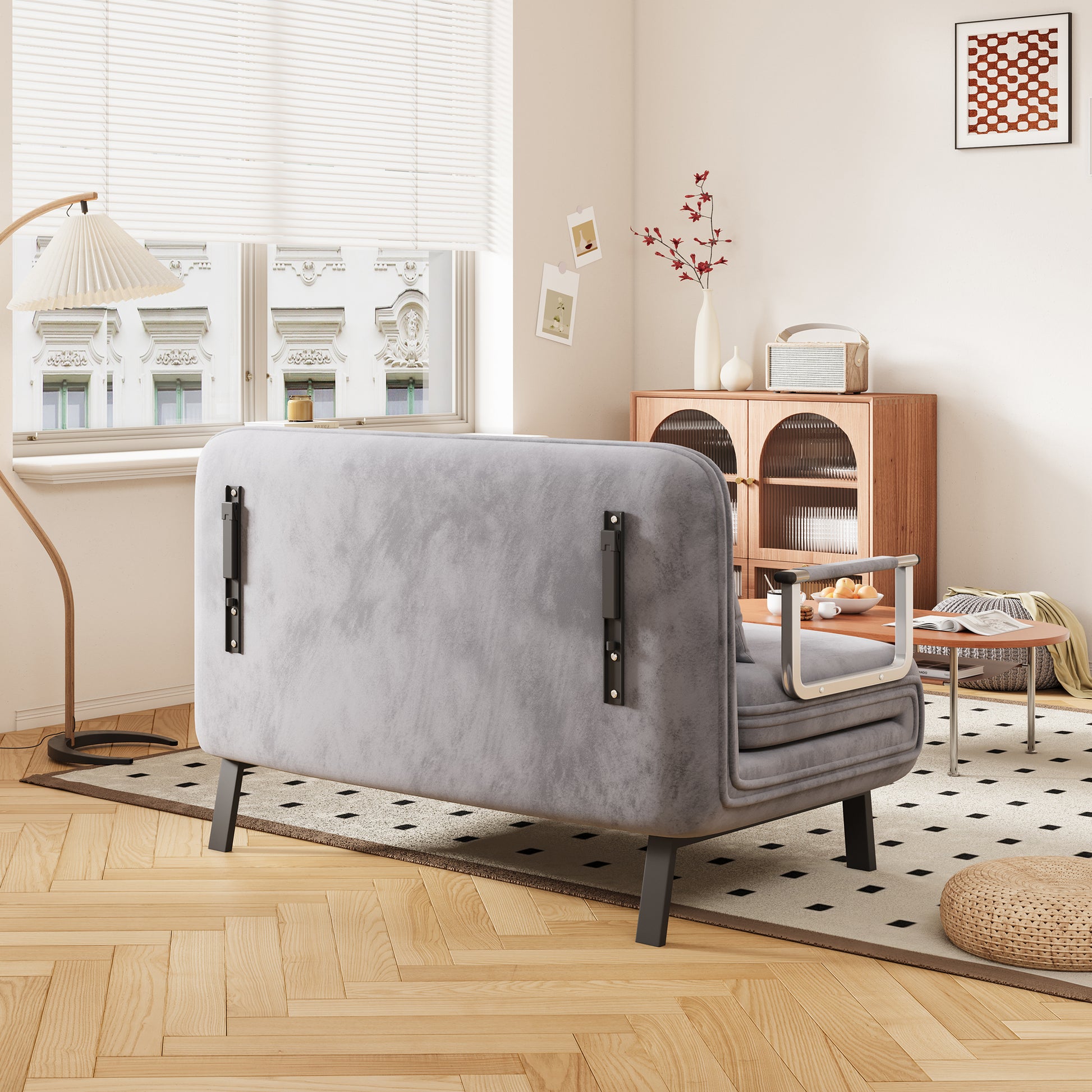 Grey velvet loveseat with metal arm accents and dark legs for a living room