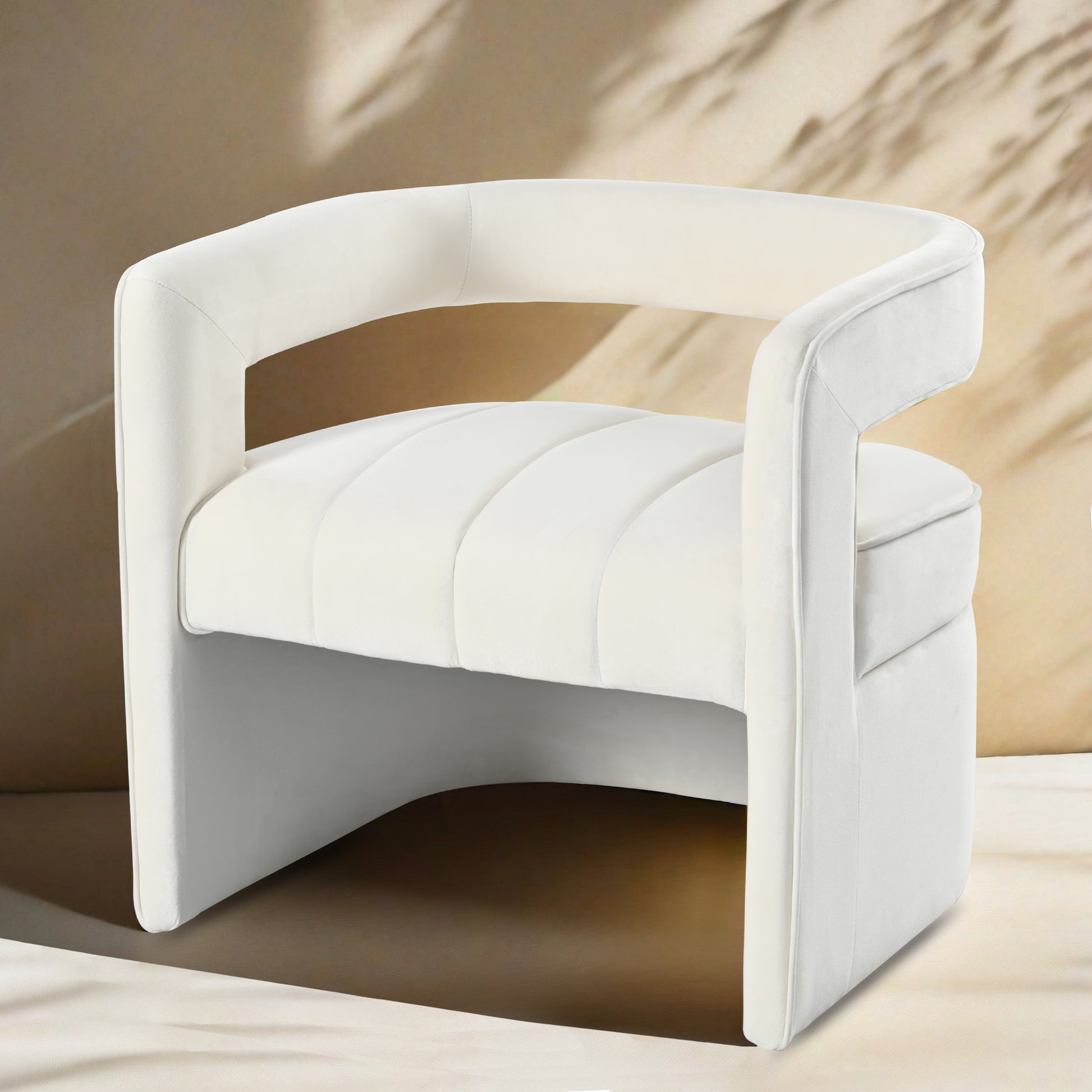 Plush white velvet accent chair with channeled seat and curved back ideal for living rooms