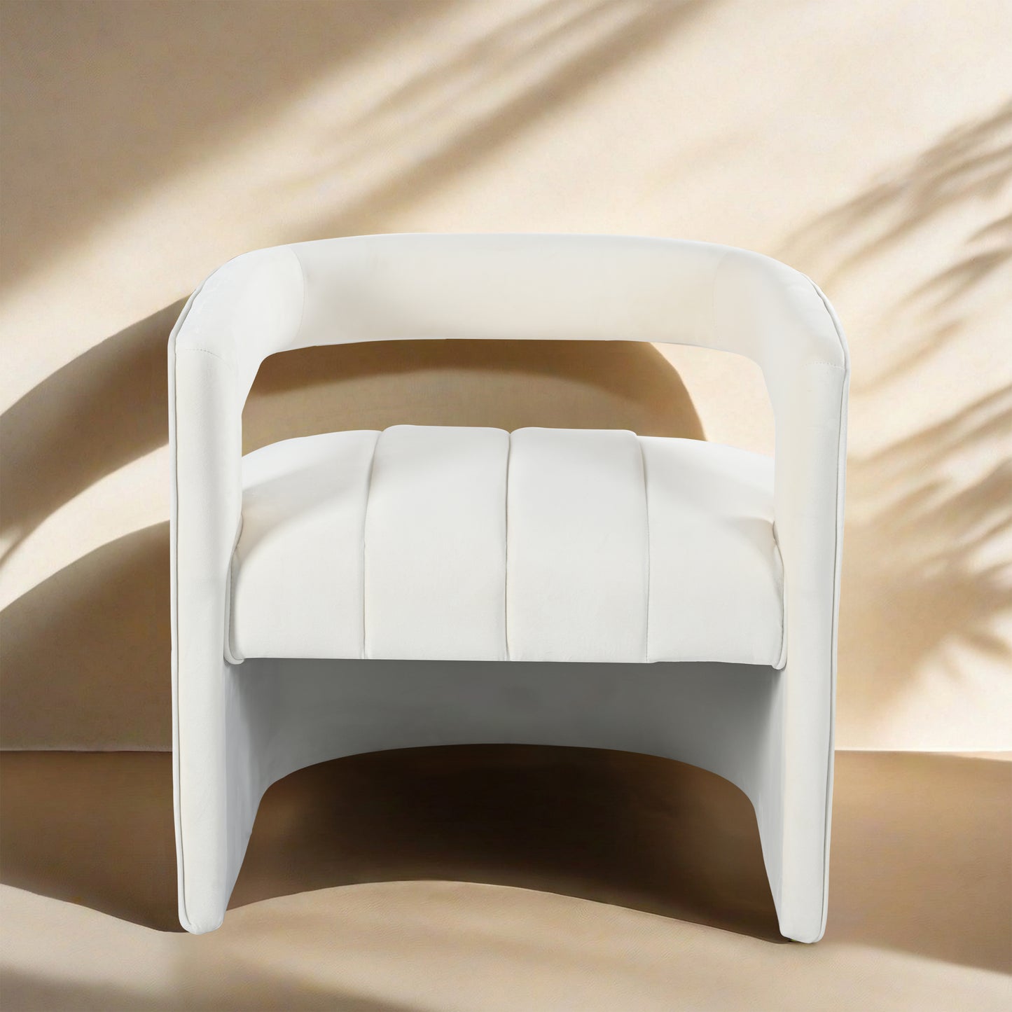 Plush white accent chair with curved arms and channeltufted seat for modern living room comfort