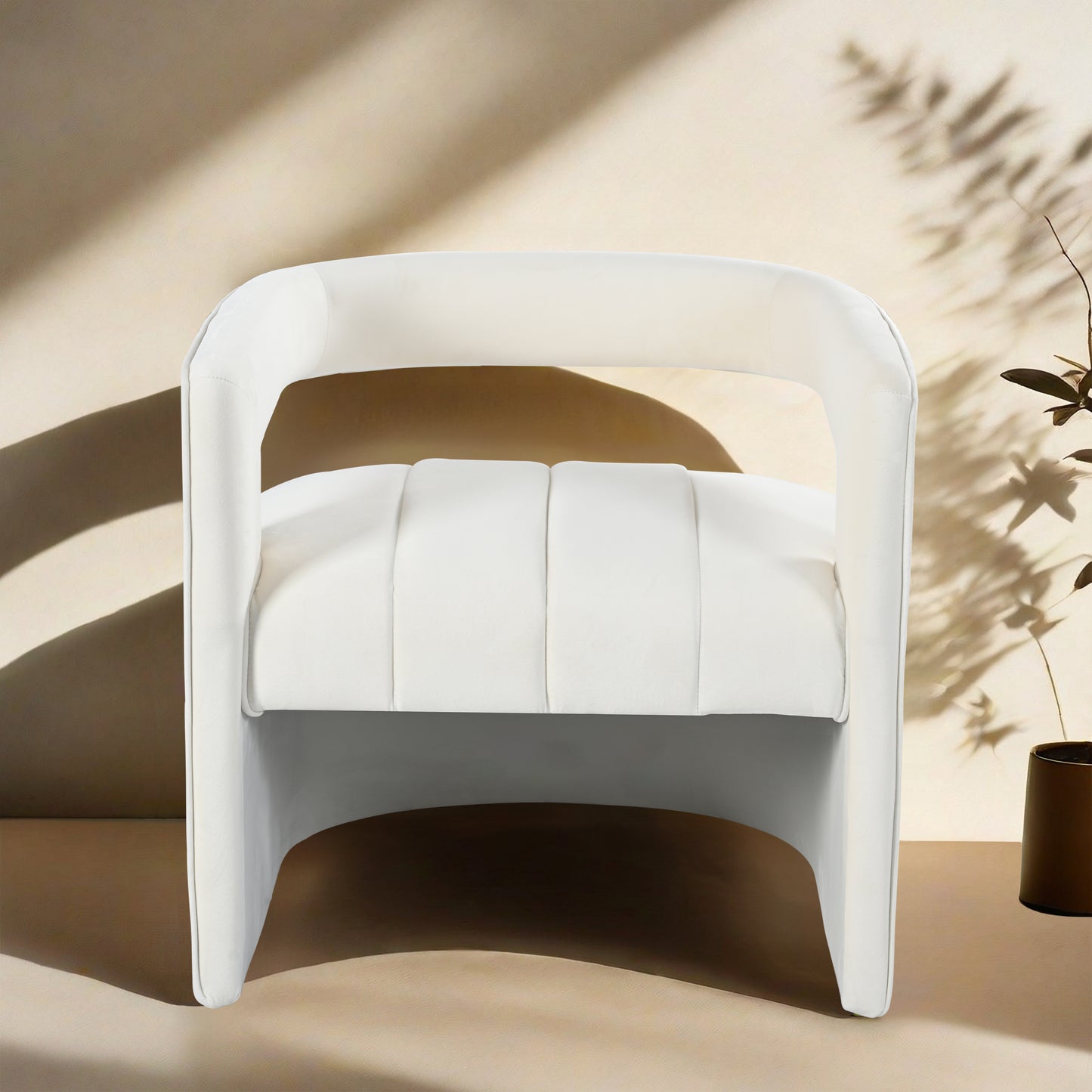 White upholstered accent chair with plush tufted seat cushion and curved arms