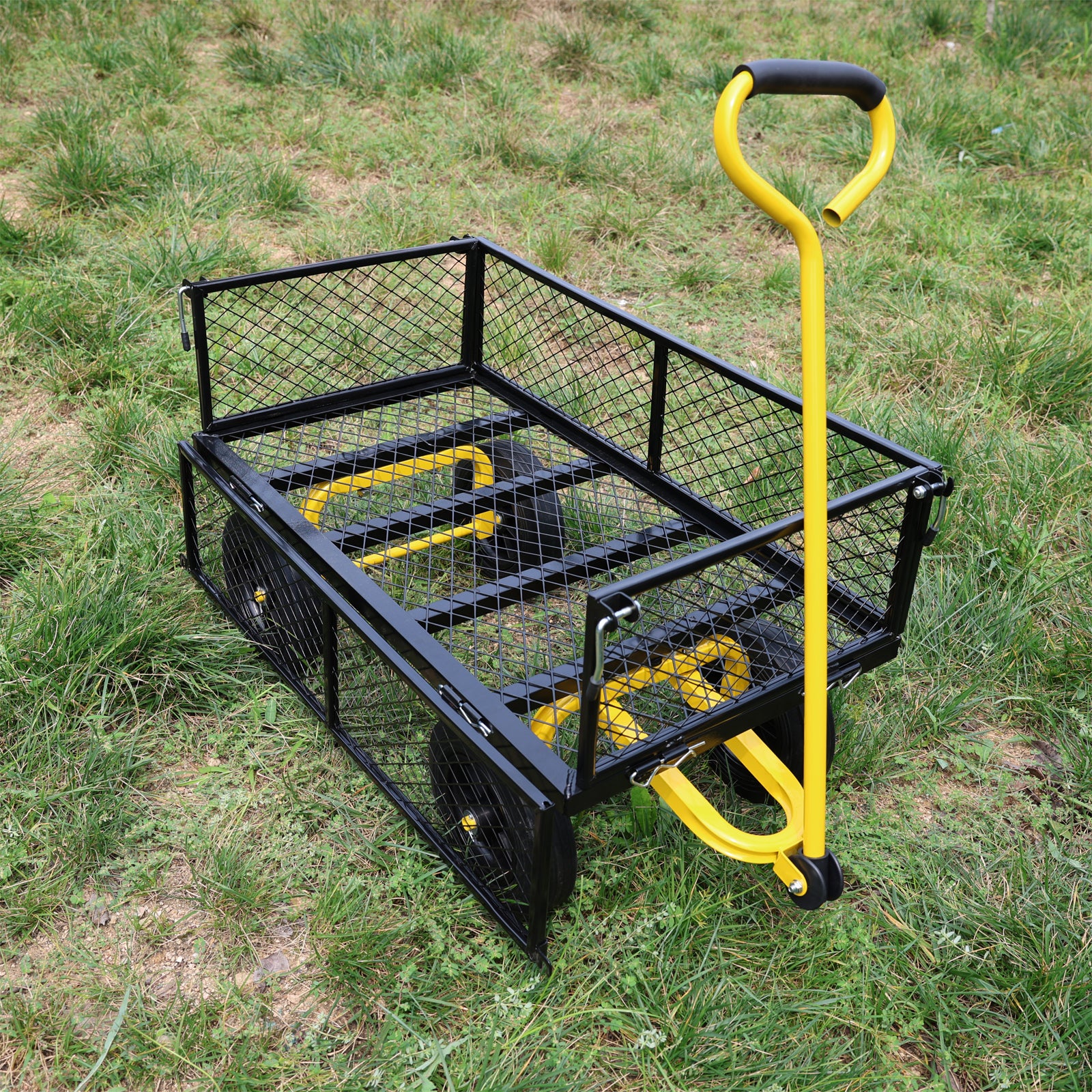 Black metal garden cart with yellow accents and a black handle on a grassy lawn