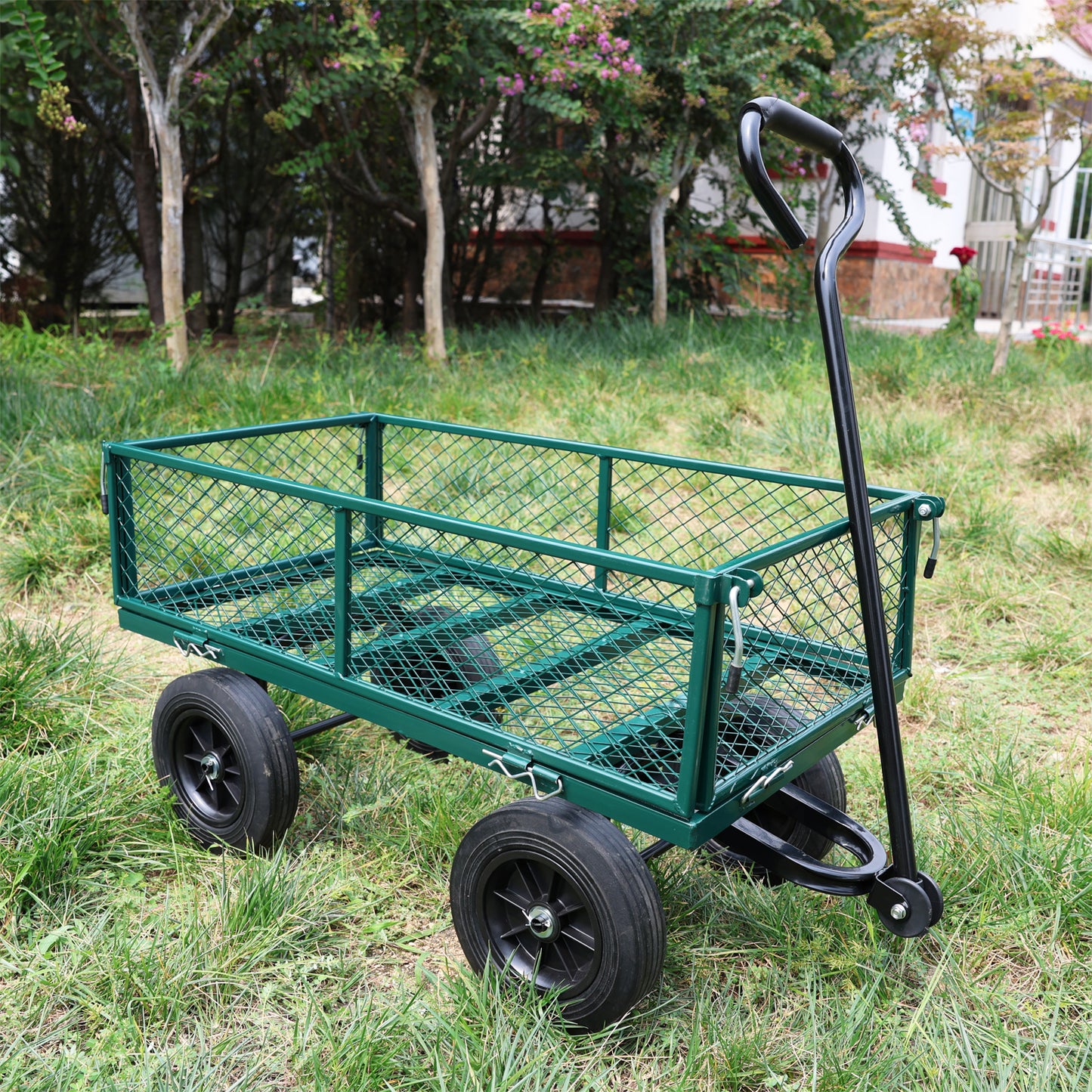 Green metal garden cart with mesh sides and black wheels ideal for hauling supplies