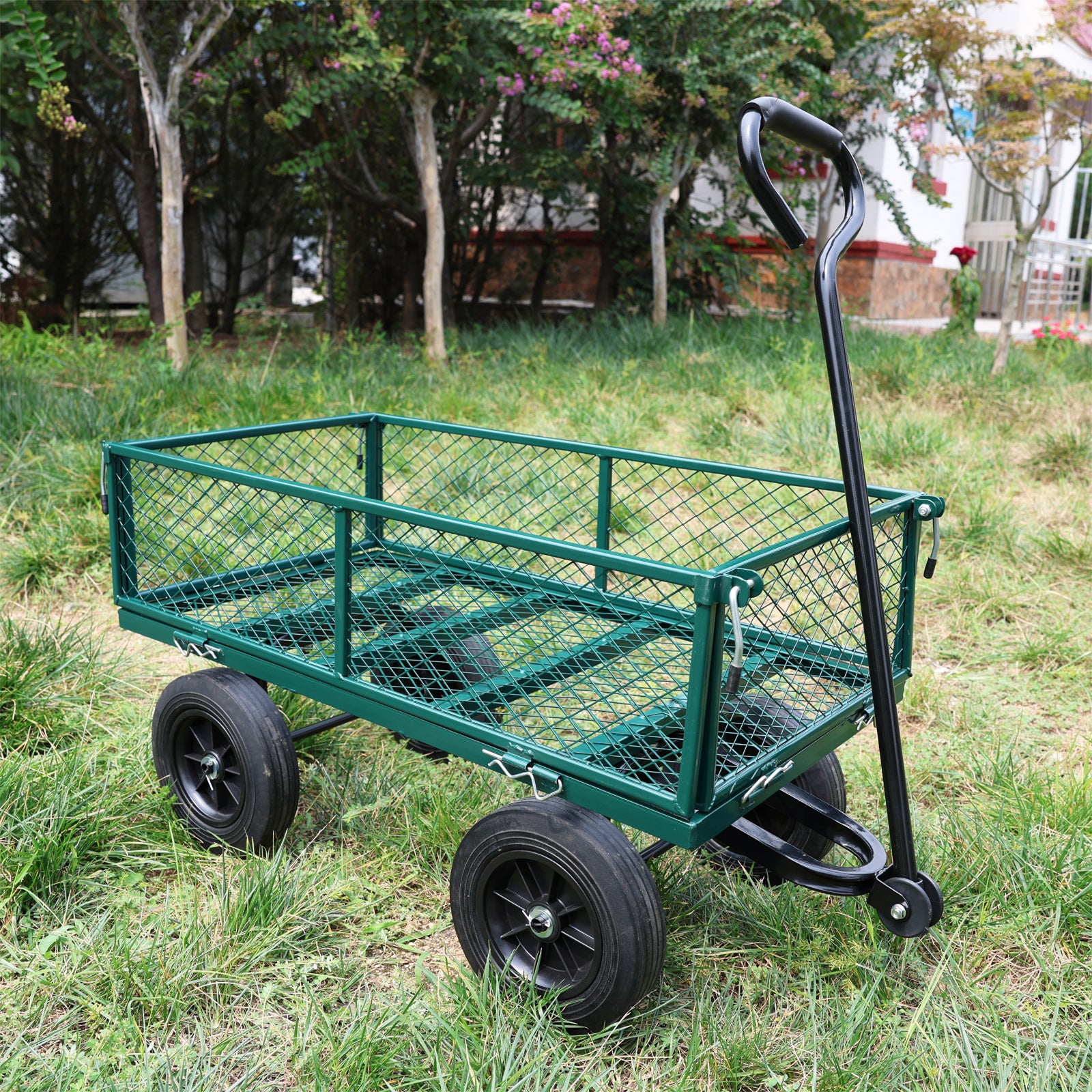 Green metal garden cart with mesh sides and black wheels ideal for hauling supplies