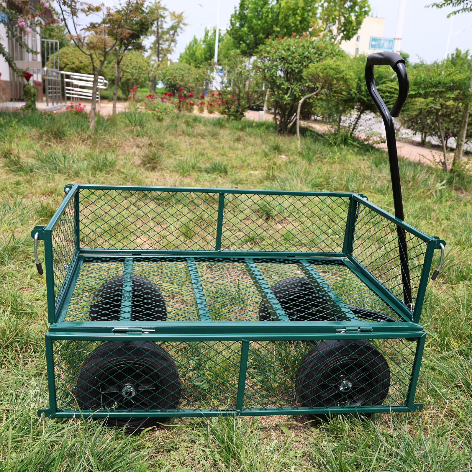 Green steel garden cart with four wheels and a pulling handle
