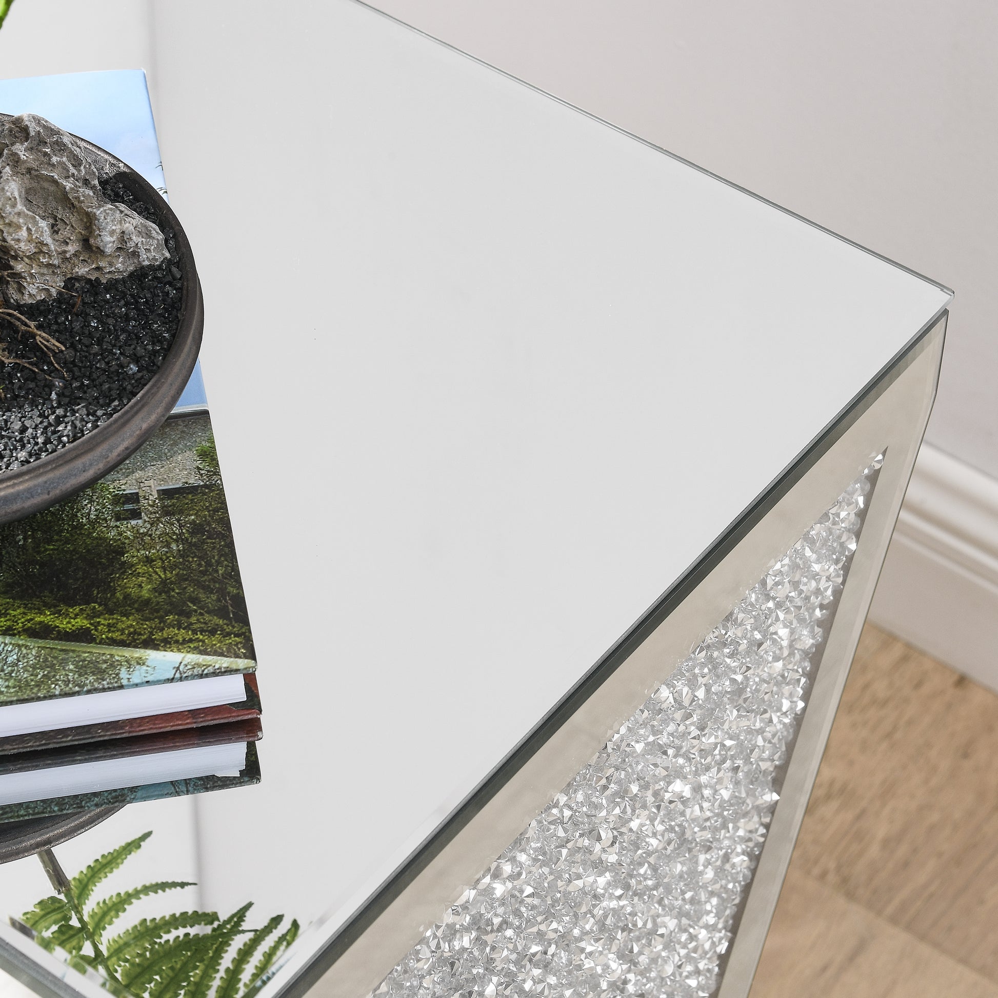 Crushed diamond mirrored side table with a sleek glass top and a decorative inlaid crystal panel