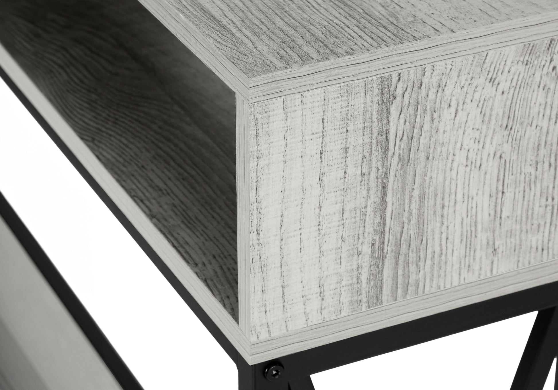 Closeup of a modern grey wood grain shelf unit with black metal legs