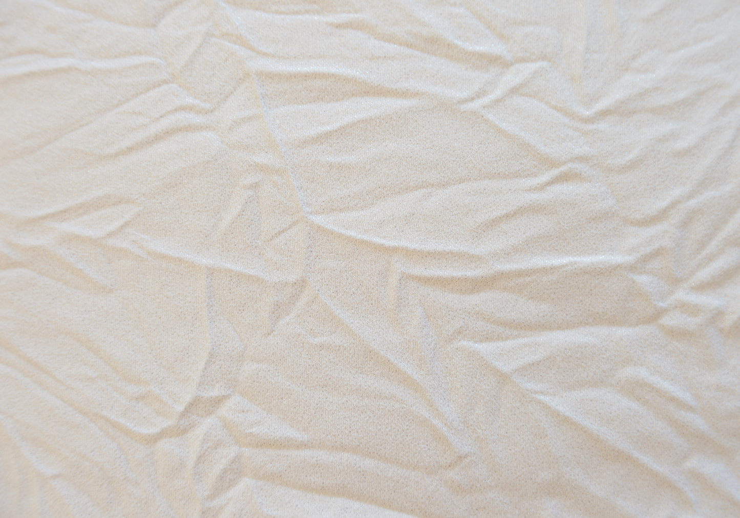 Light beige textured fabric with subtle sheen ideal for upholstery