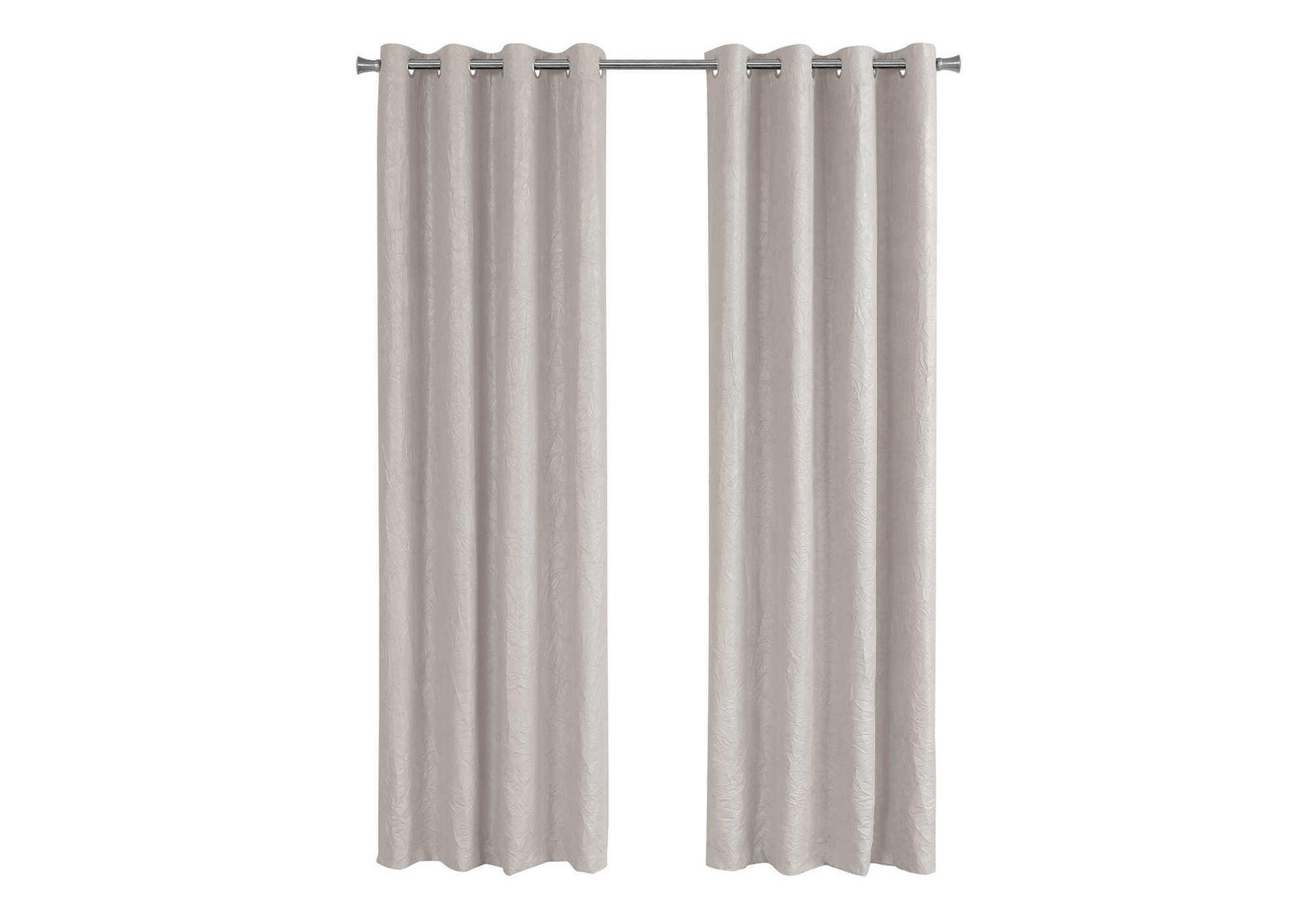Pair of textured neutral linen blend grommet top curtains hanging on a rod