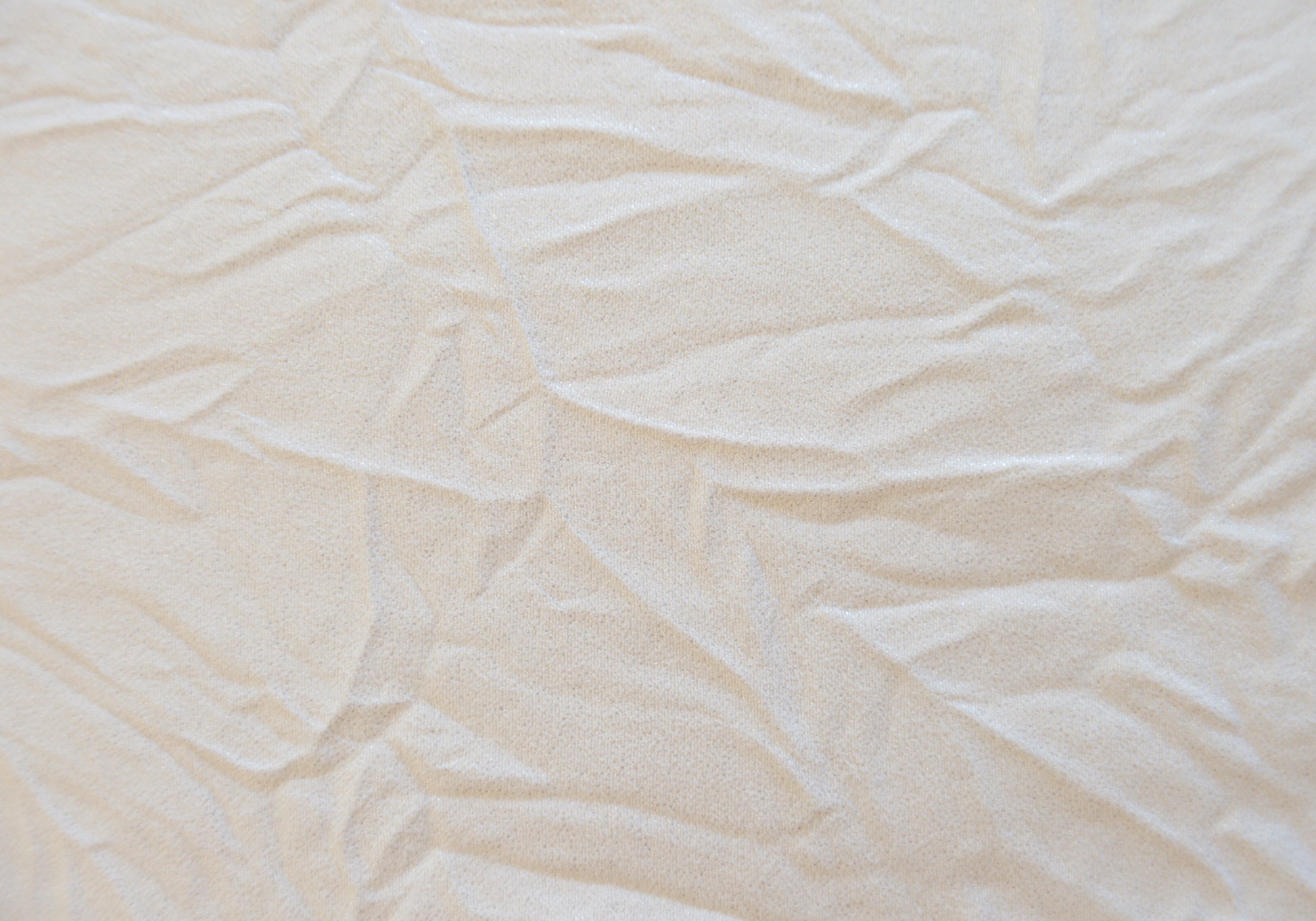Cream textured fabric with subtle glitter threads ideal for event decor