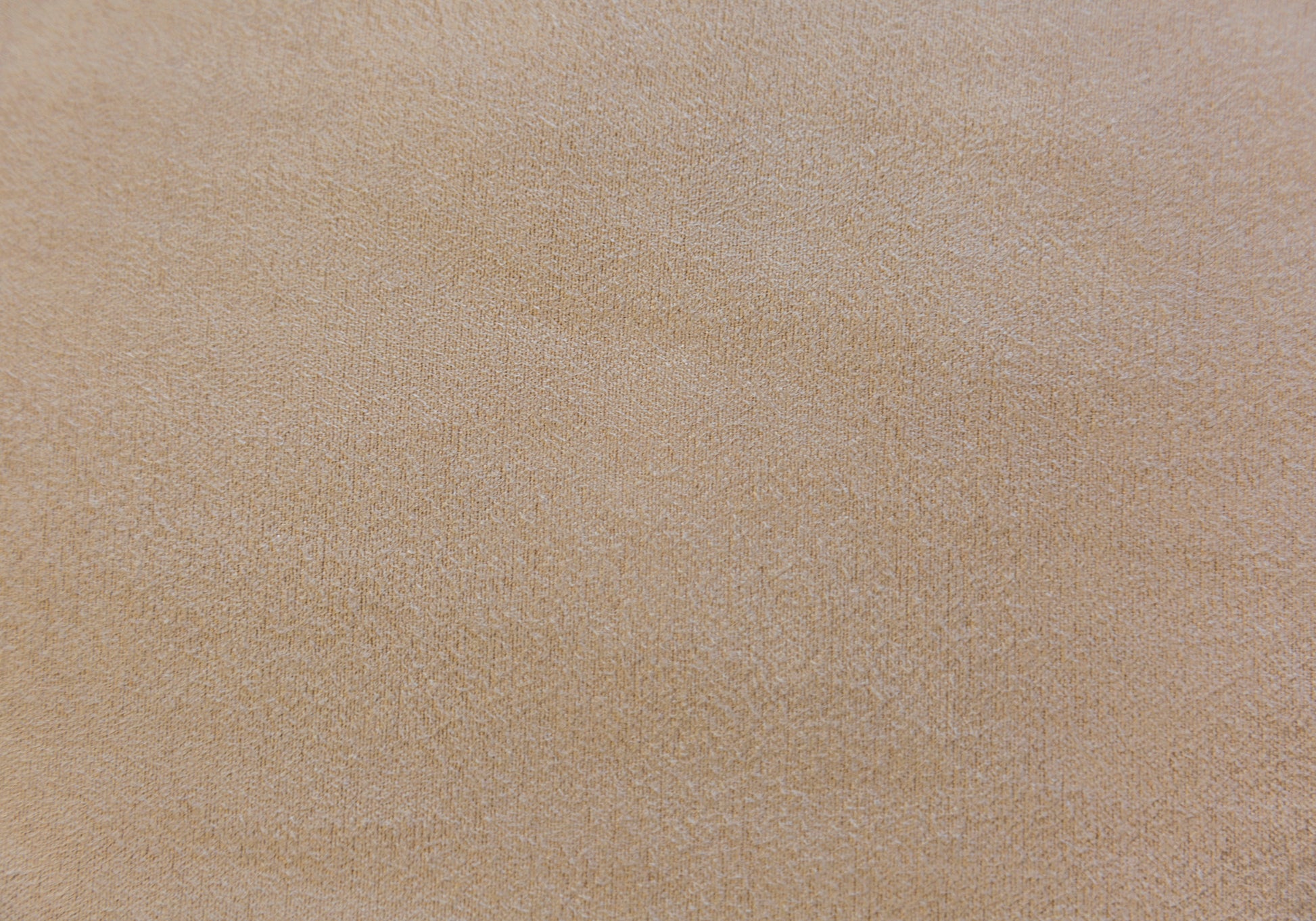 Closeup of a textured beige fabric ideal for upholstery or home decor applications