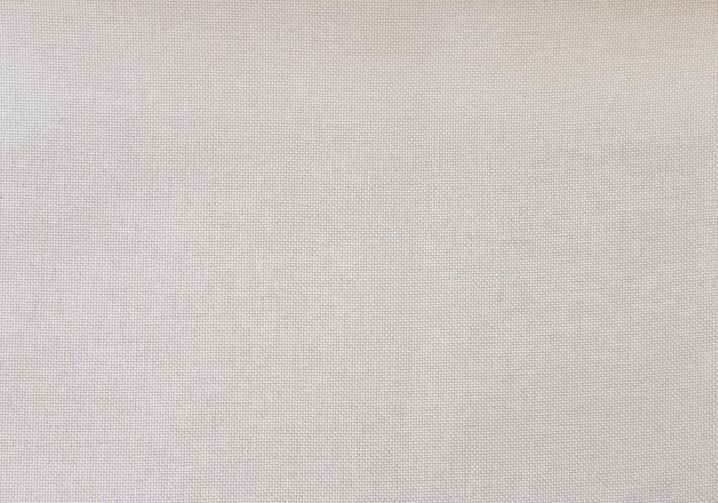 Closeup texture of natural linen fabric in a light beige hue ideal for upholstery