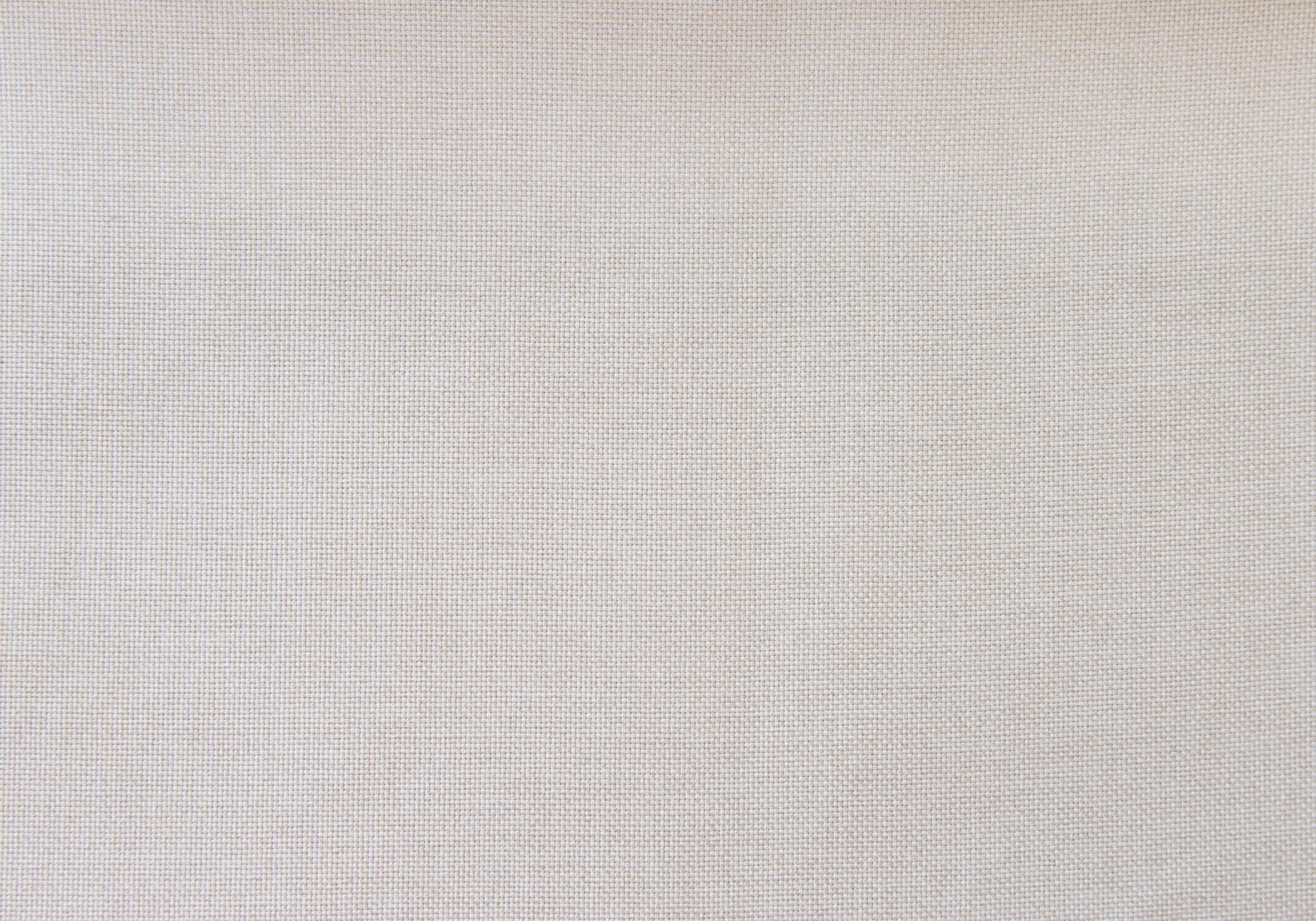 Closeup texture of natural linen fabric in a light beige hue ideal for upholstery