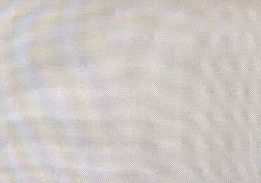 Closeup texture of natural linen fabric in a light beige hue ideal for upholstery