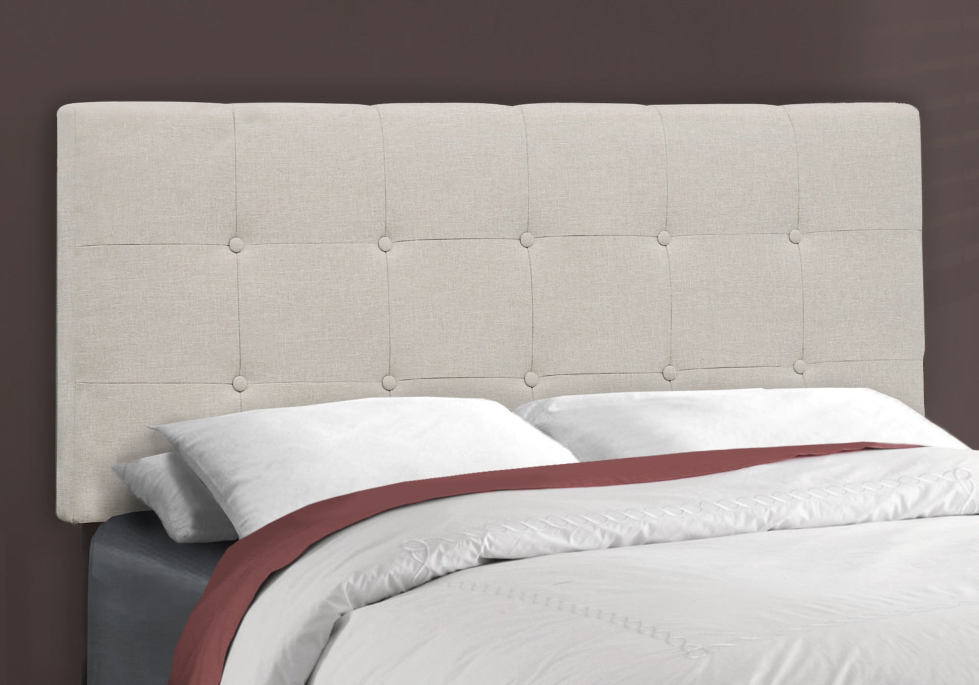 Tufted linen beige headboard with button accents for a modern bedroom