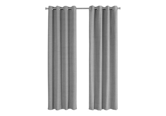 Two plain grey grommet curtains hanging on a metal rod