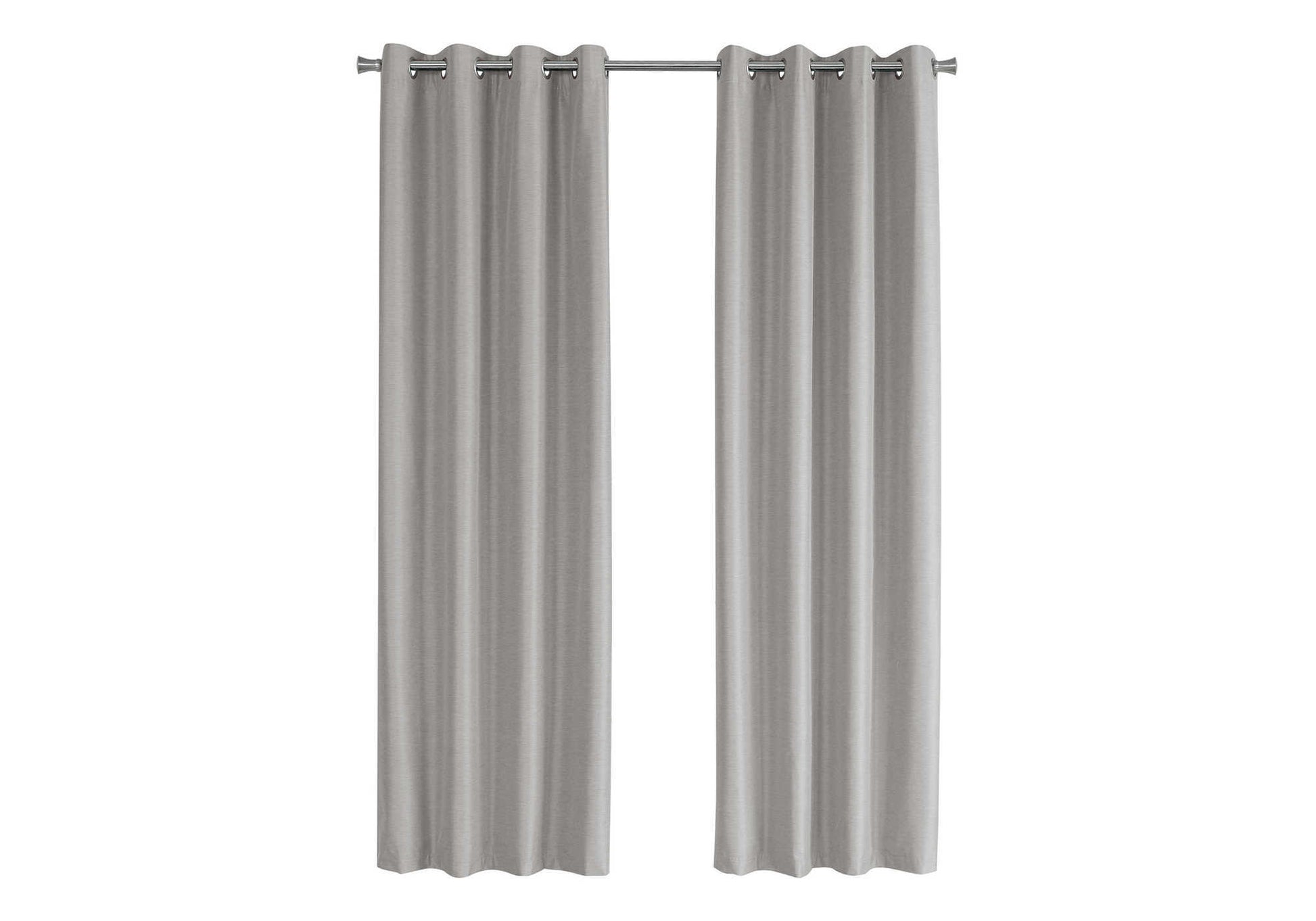 Two light gray textured grommet curtains hanging on a silver rod