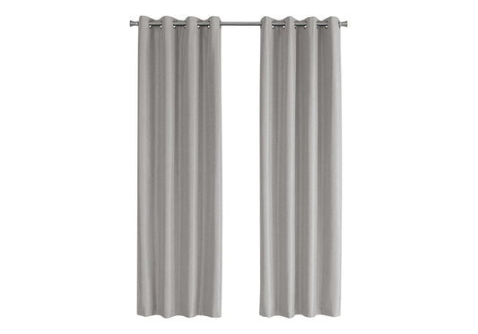 Two light gray textured grommet curtains hanging on a silver rod