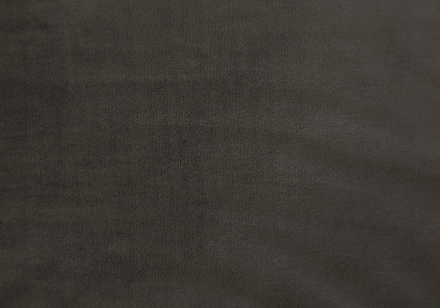 Closeup of dark grey velvet fabric texture ideal for upholstery