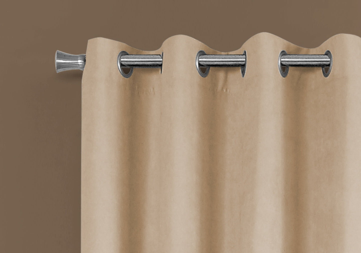 Grommet curtain in a neutral beige fabric hanging on a silver rod