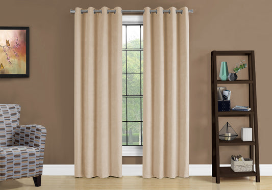 Grommet top beige velvet curtains hanging across a window providing room darkening