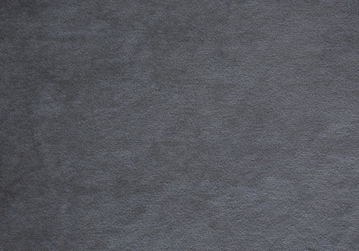 Closeup of textured charcoal grey velvet fabric for upholstery projects