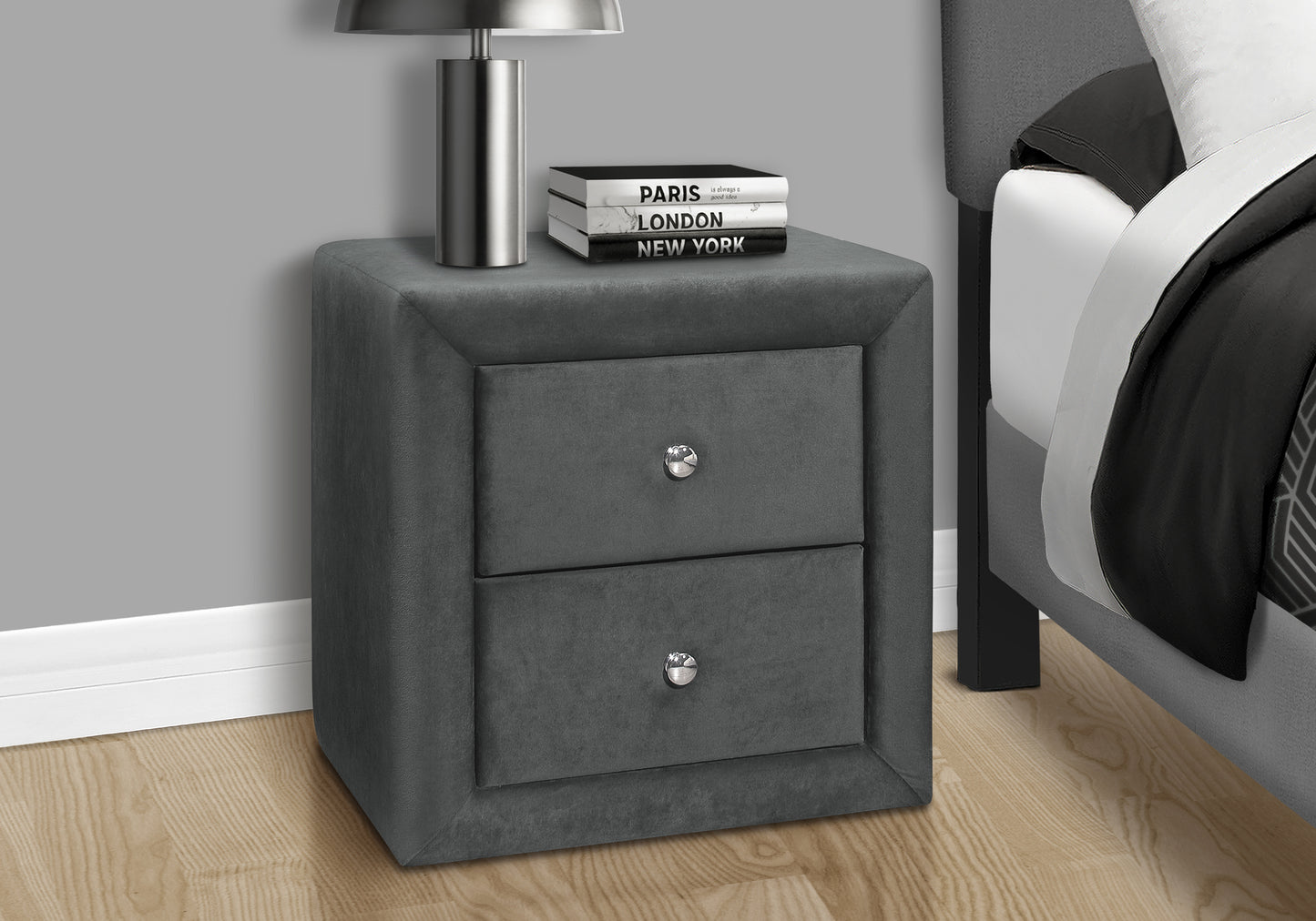Plush dark grey velvet nightstand with two drawers and silver knobs