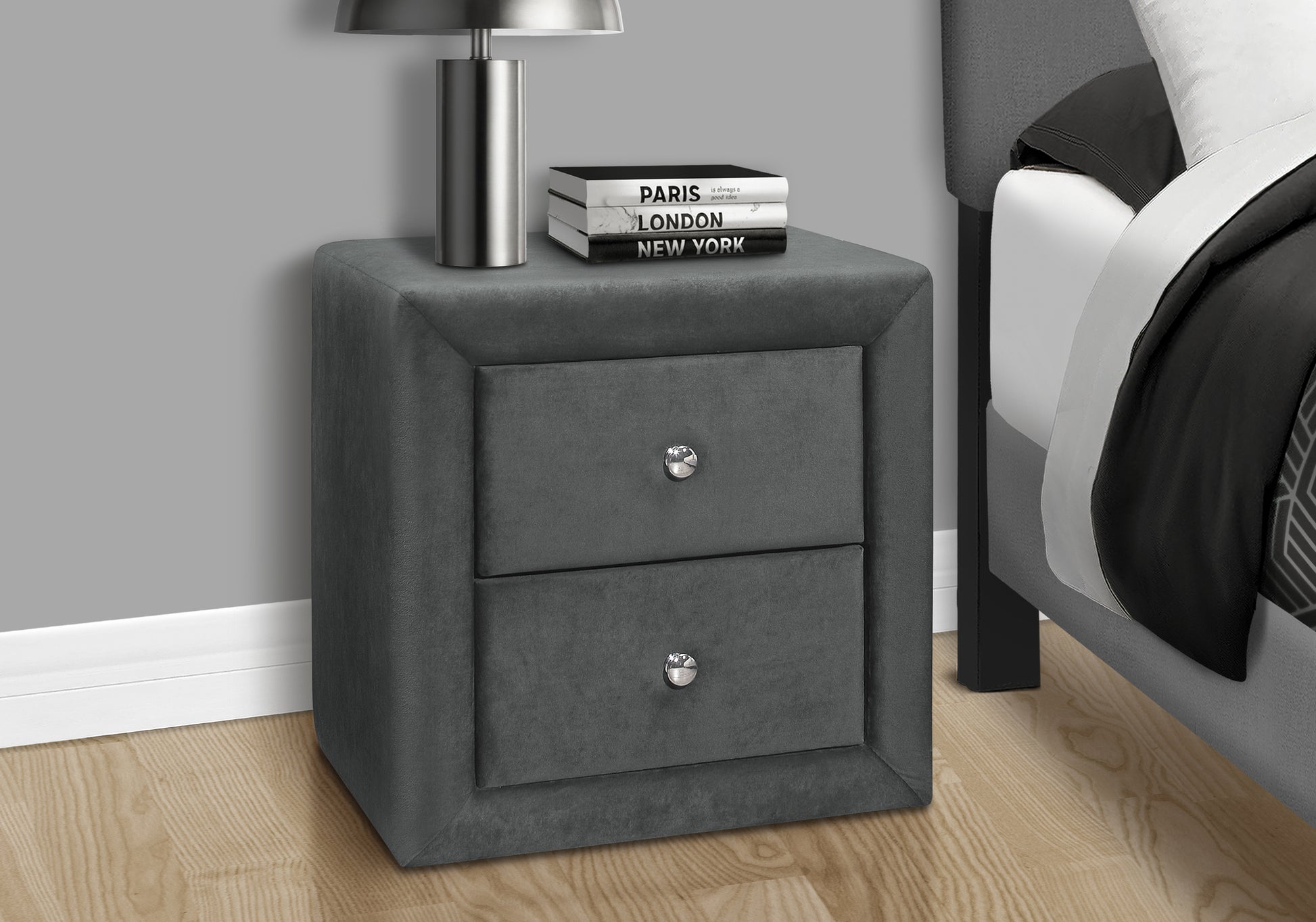 Plush dark grey velvet nightstand with two drawers and silver knobs