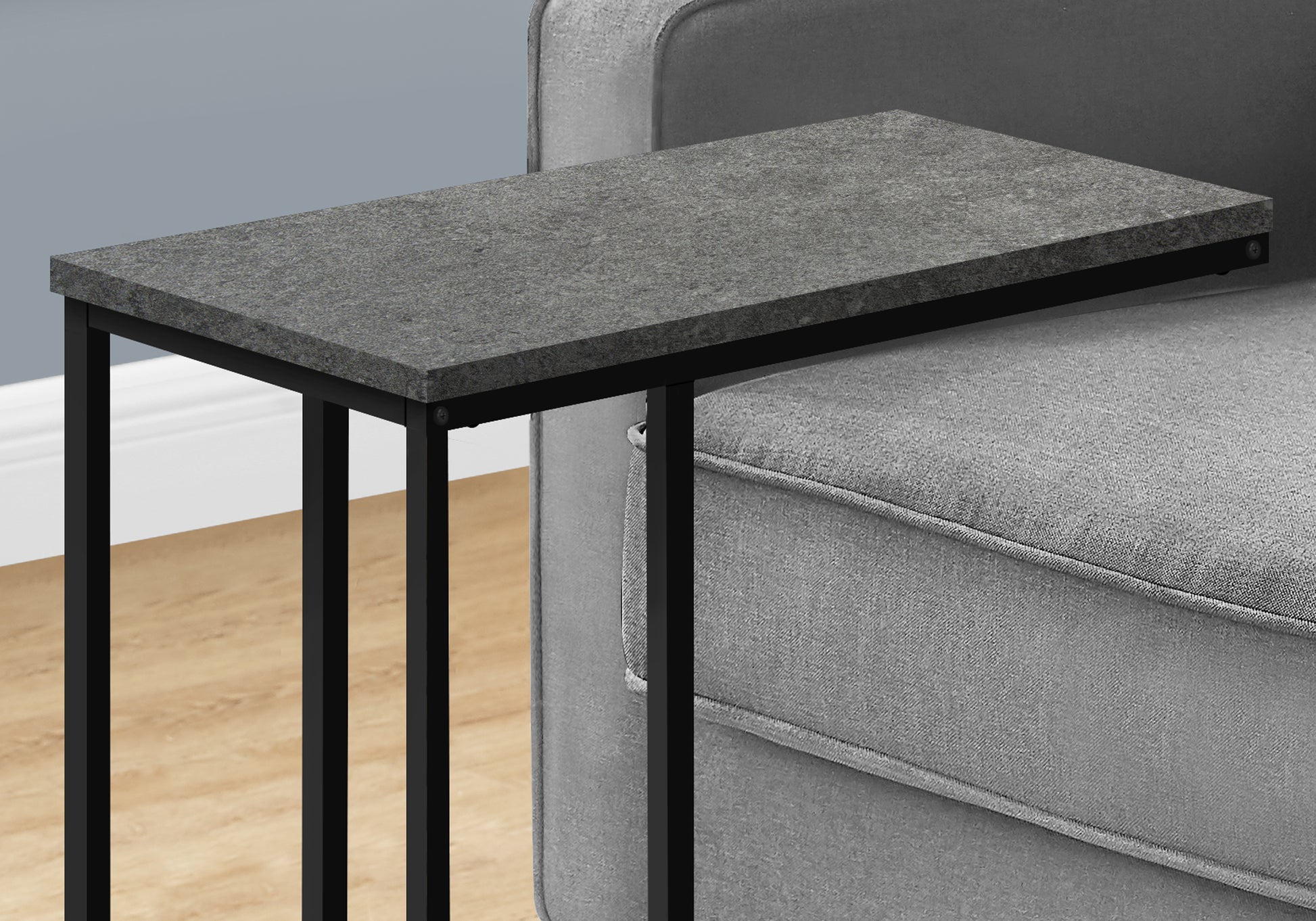 Gray faux marble ctable with black metal legs slides under sofa for convenient side table use