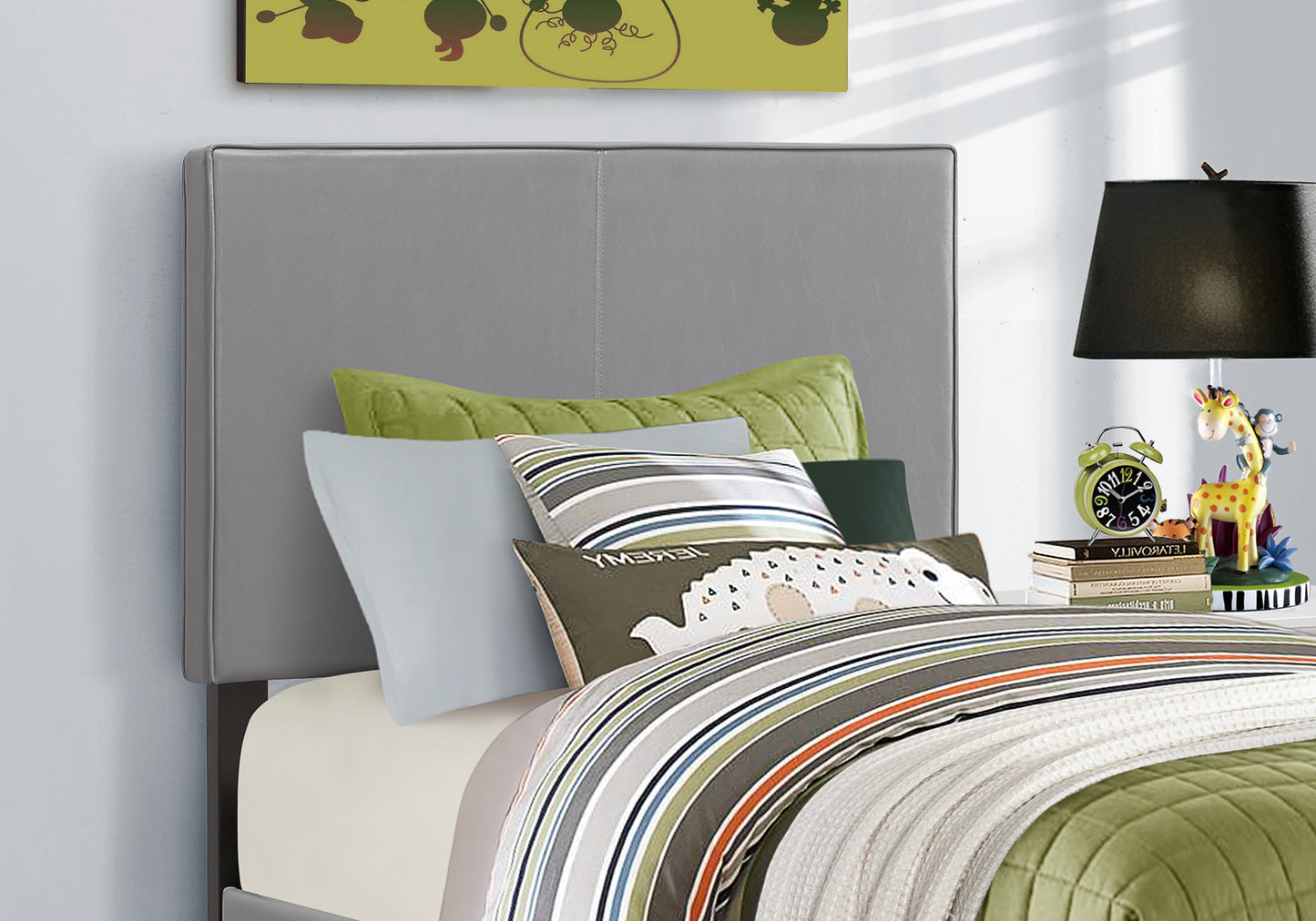 Grey upholstered headboard with decorative stitching on queen size bed