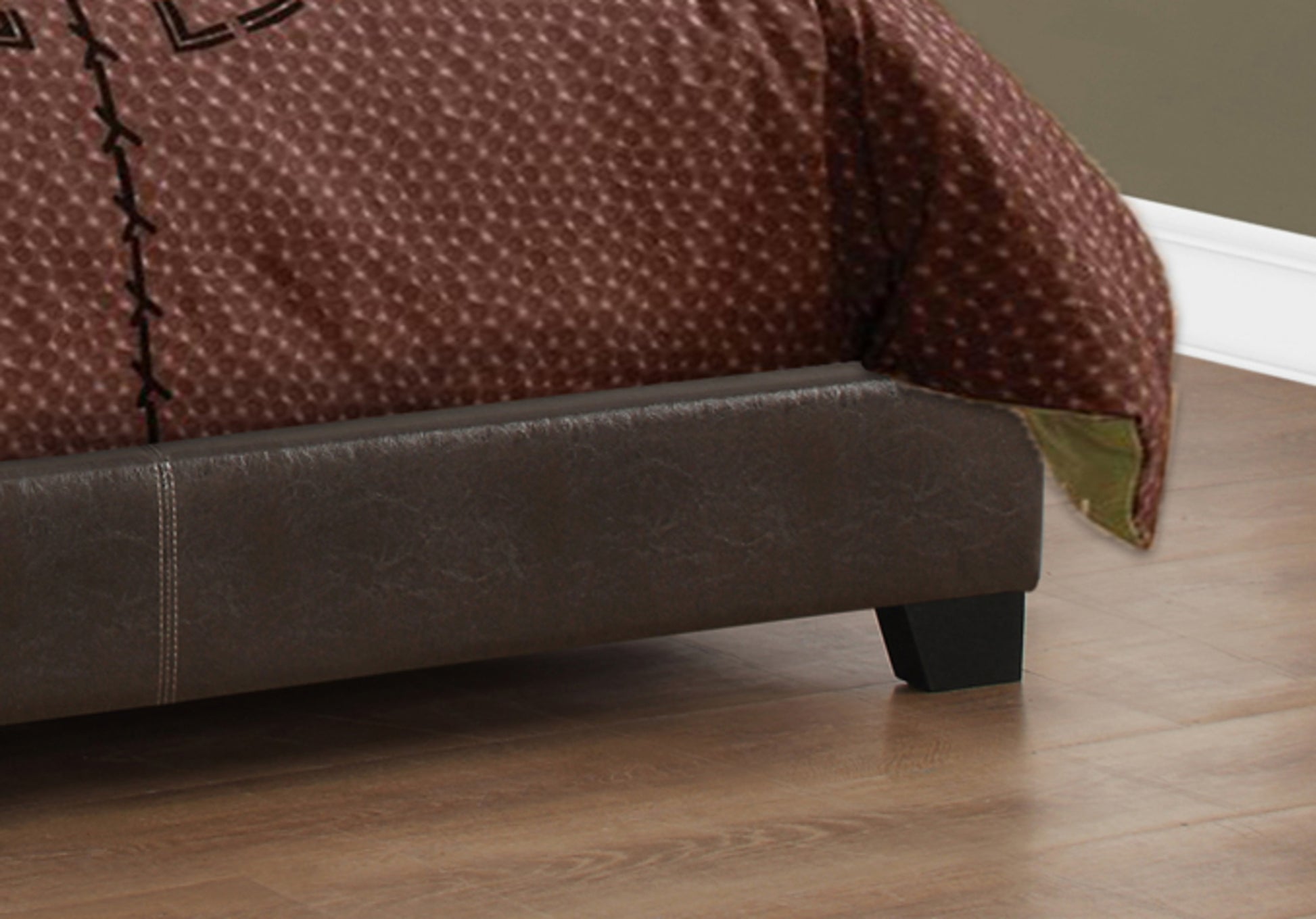 Rich brown faux leather bed frame with subtle stitching detail featuring a textured duvet