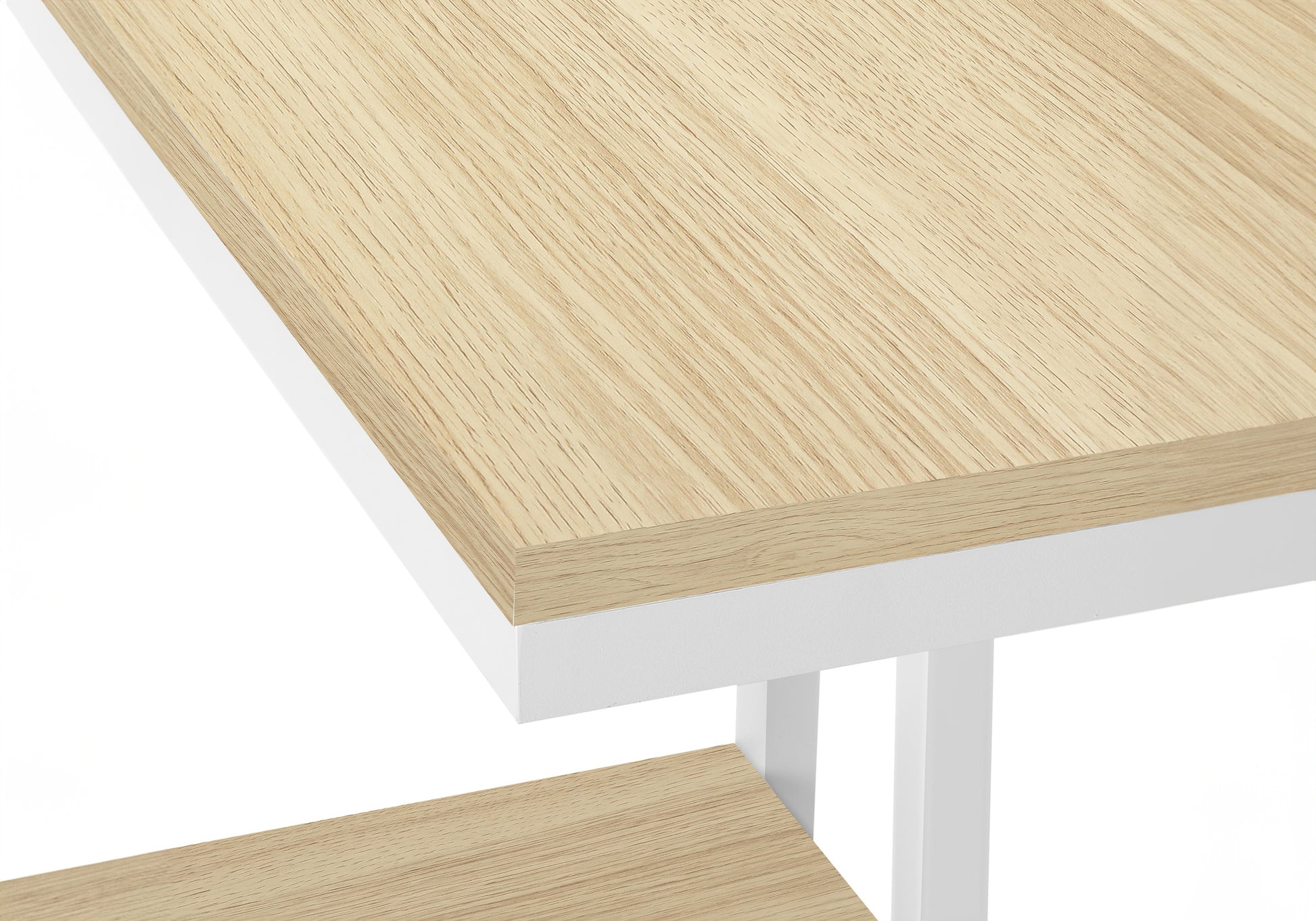 Closeup of light oak wood grain texture on a modern whiteframe desk