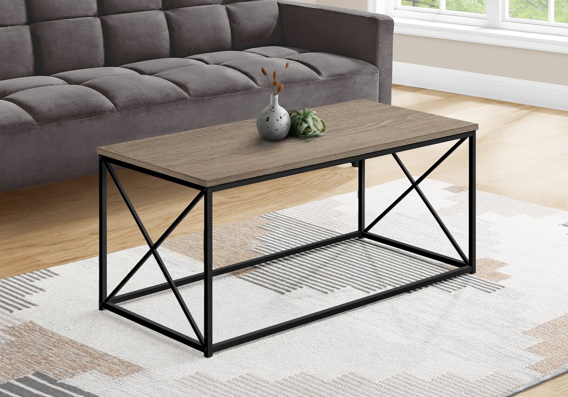 Rectangular wood top coffee table with black metal frame and crisscross legs
