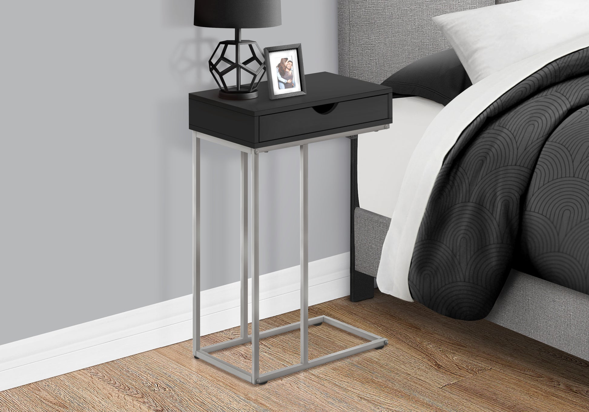 Sleek black C table with silver metal frame perfect accent for modern living spaces