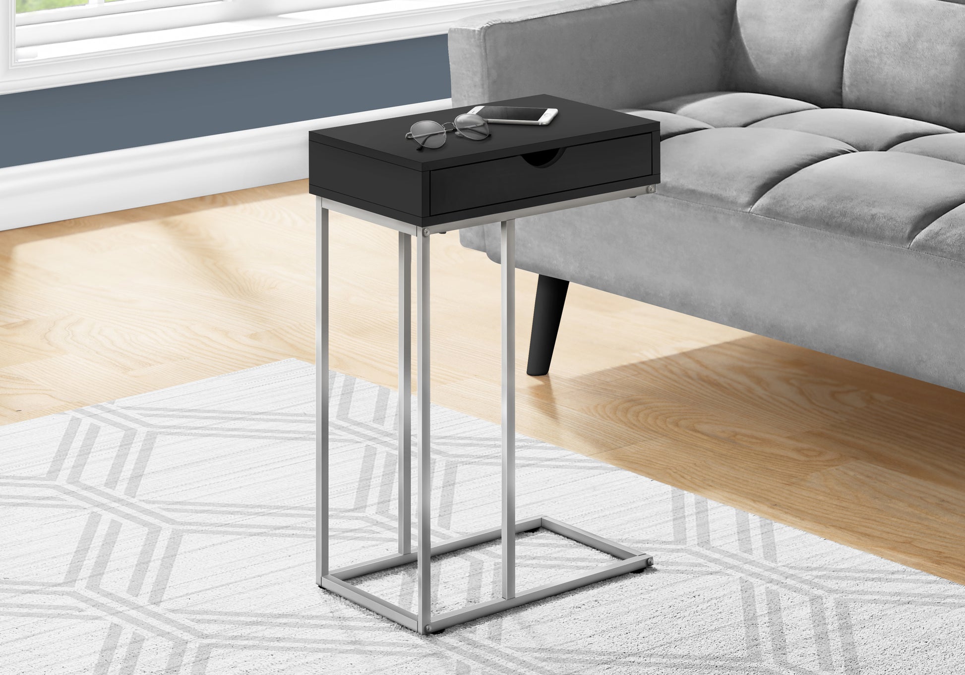 Sleek black Ctable with drawer and silver metal frame perfect for small spaces