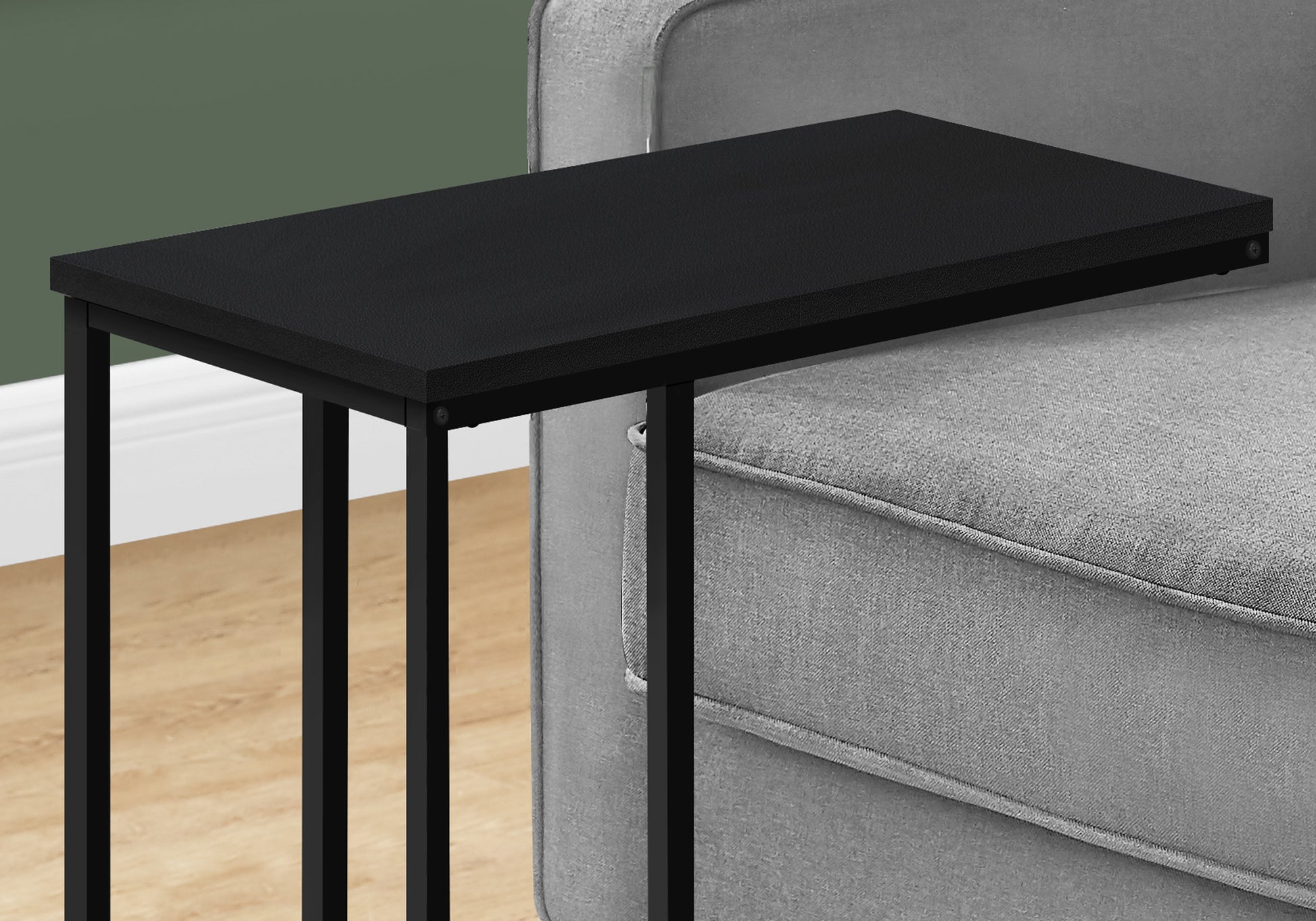 Black Ctable with textured top slides under sofa for easy use
