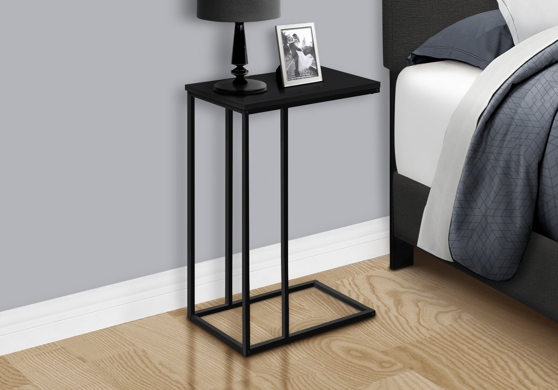 Sleek black metal Ctable with a minimalist design perfect for bedside use