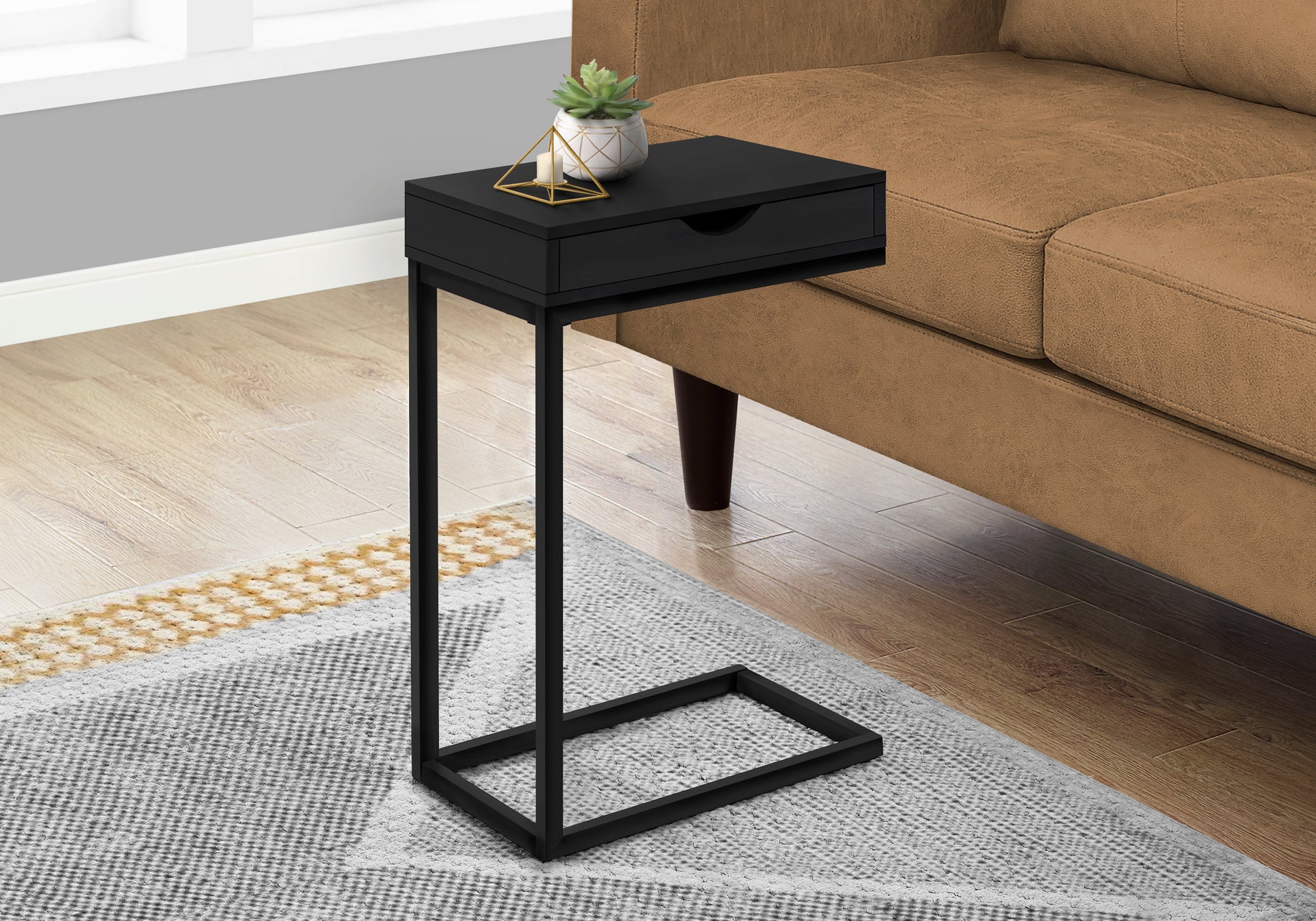 Sleek black Ctable with drawer perfect for beside a sofa