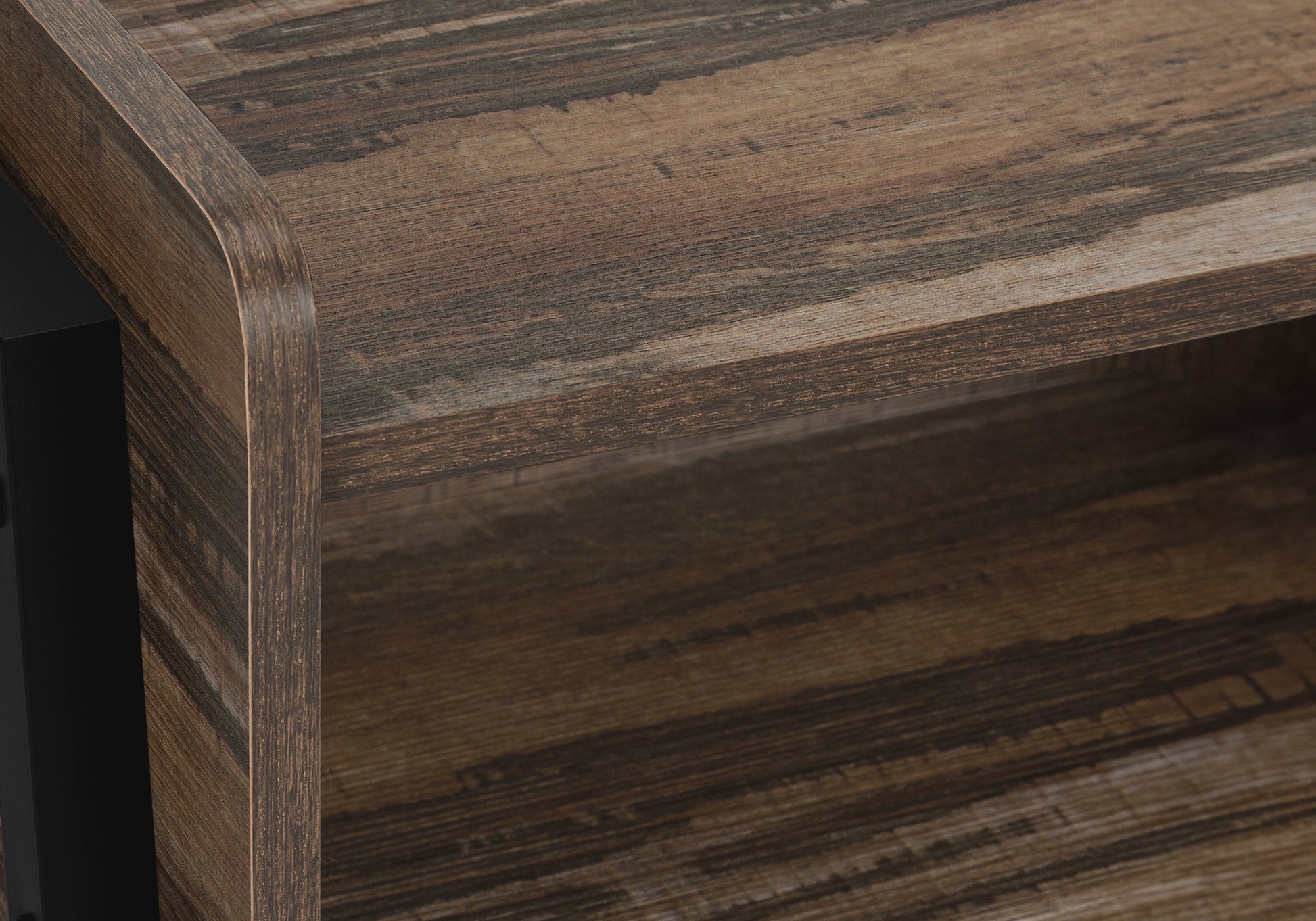 Closeup of distressed wood veneer shelf with dark grain pattern