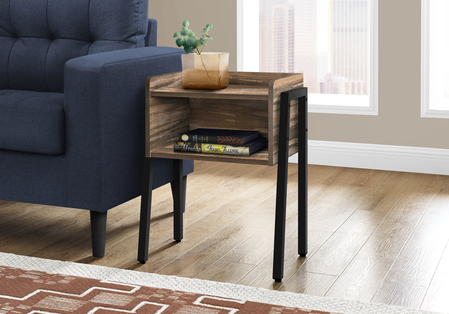 Rustic wood end table with black metal legs and two shelves holding books and vase
