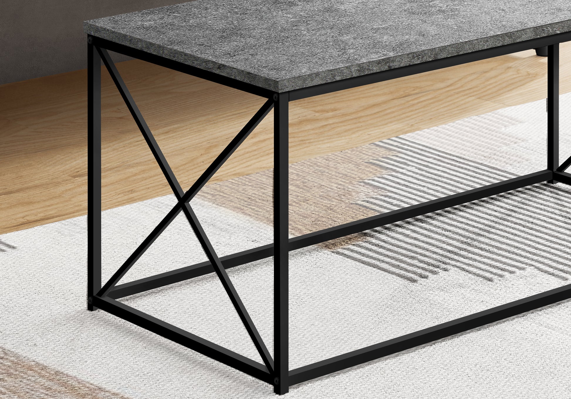 Modern grey stone top coffee table with black metal frame and Xleg design