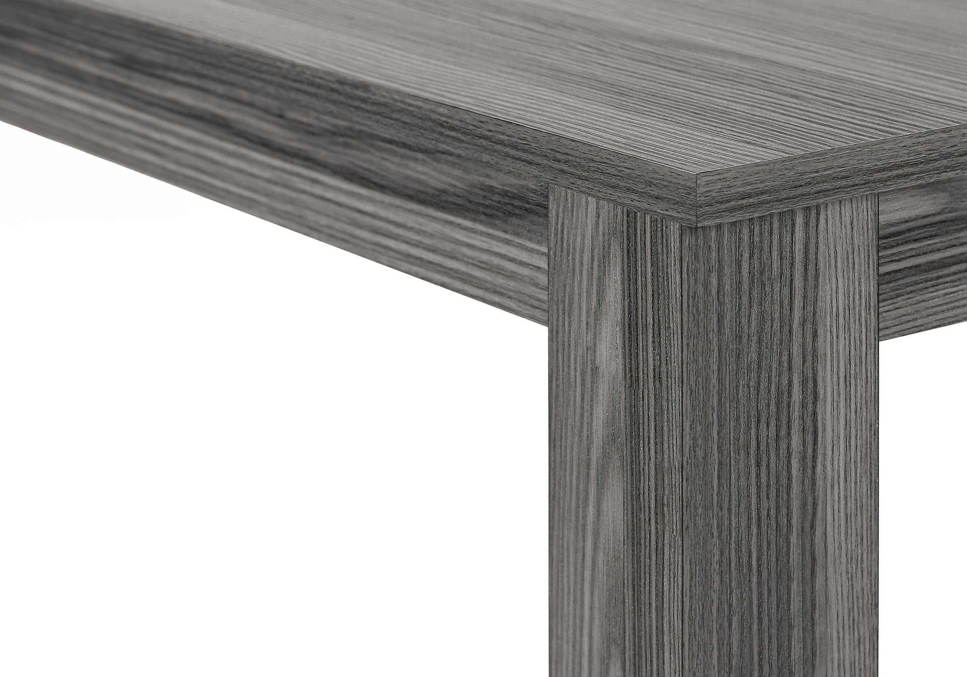Closeup of a grey wood grain laminate table edge and leg