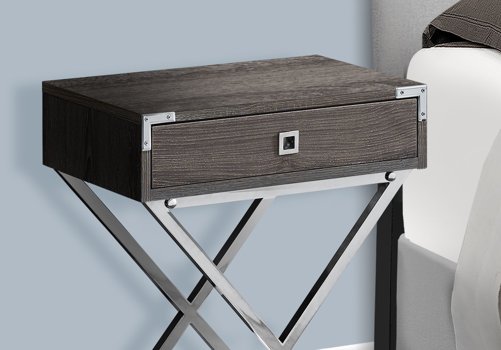Dark wood bedside table with a silver drawer pull and metallic Xshaped legs