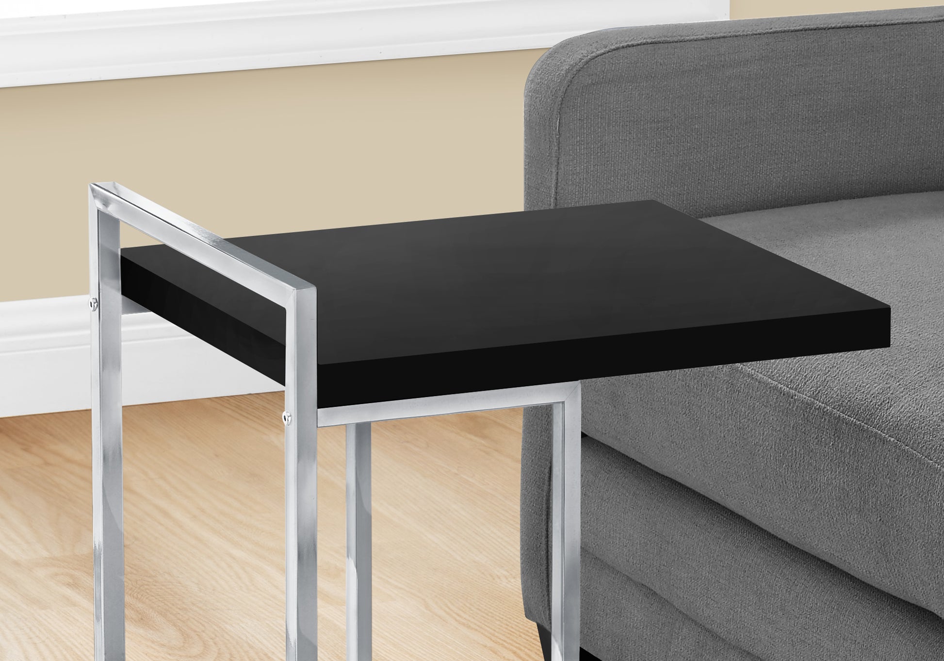 Sleek black Ctable with a chrome metal frame perfect for bedside use