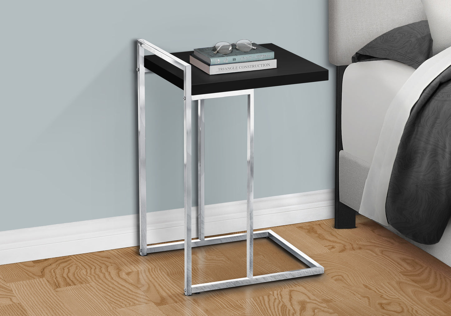 Black accent table with chrome frame perfect for bedside use