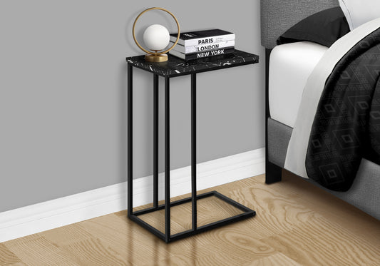 Sleek black metal Ctable with faux marble top and modern lamp beside bed