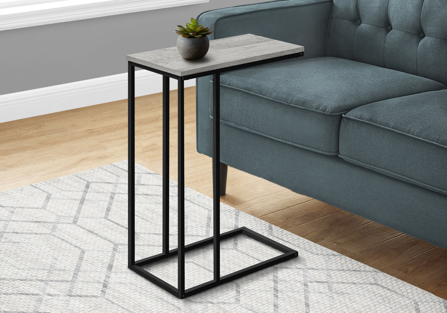 Gray wood finish Ctable with black metal frame and a small potted succulent