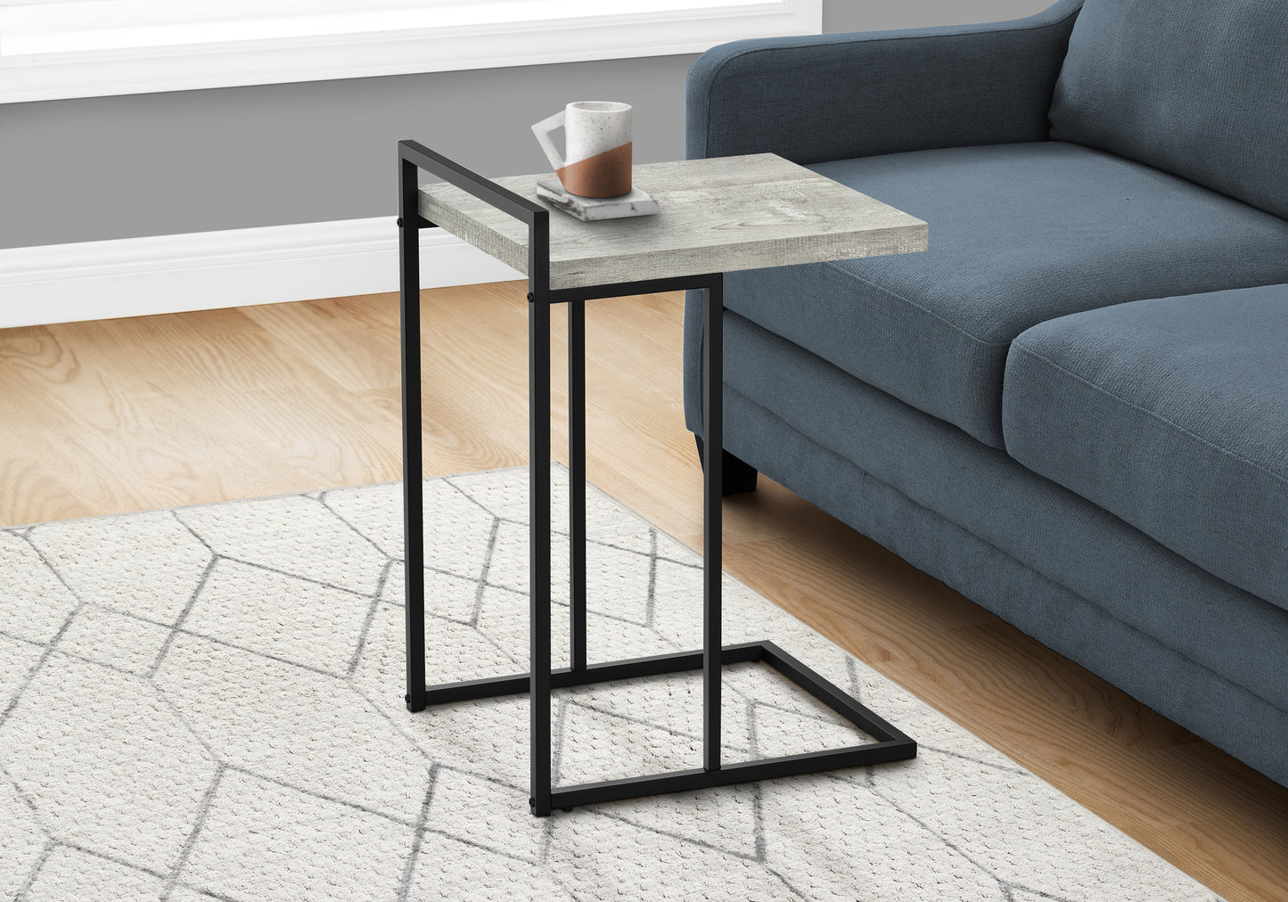 Modern gray wood and black metal ctable with a marble coaster and mug