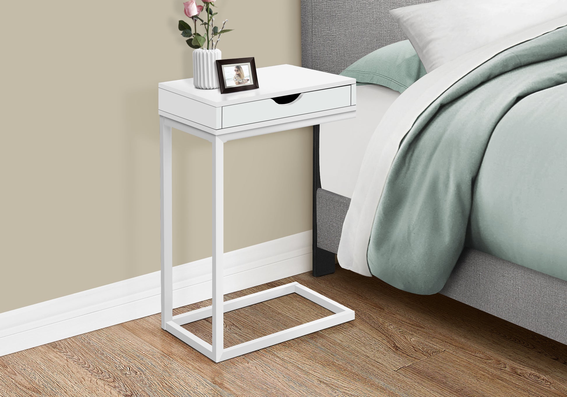 White Ctable with drawer beside bed featuring metal frame for easy access