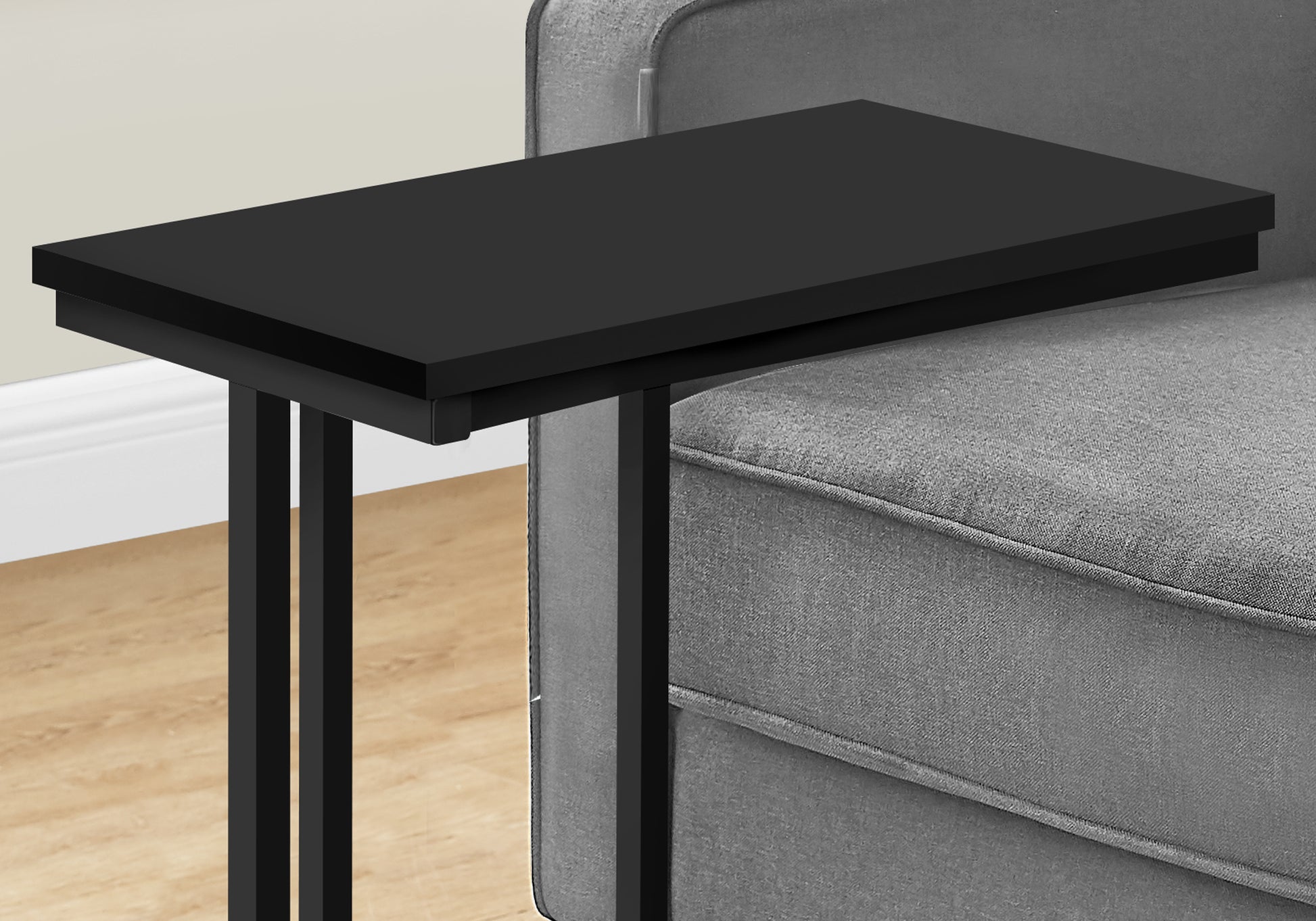 Sleek black metal Ctable with a smooth top perfect for beside a sofa