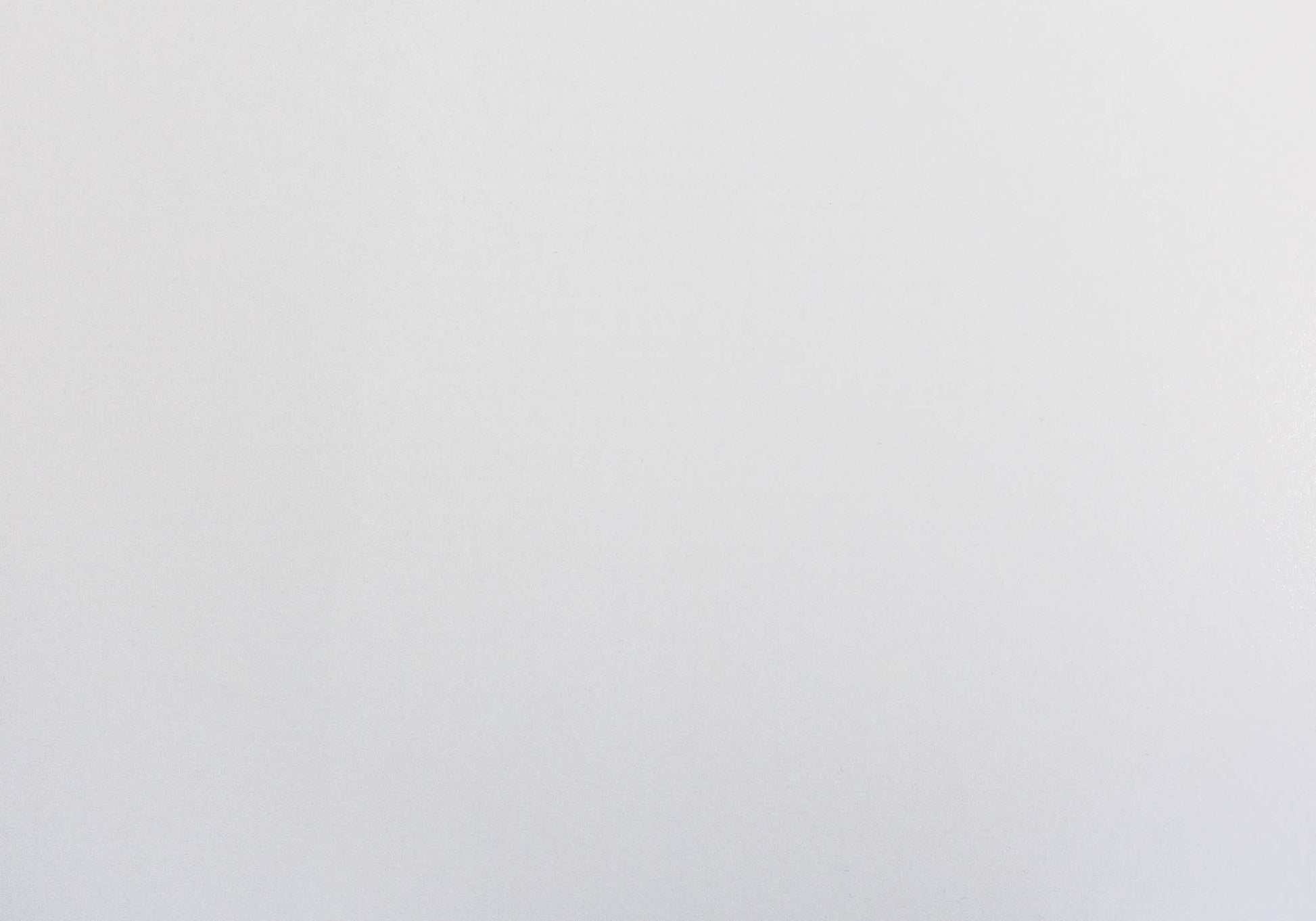 Flat lay of a crisp white linen tablecloth perfect for a minimalist dining setting